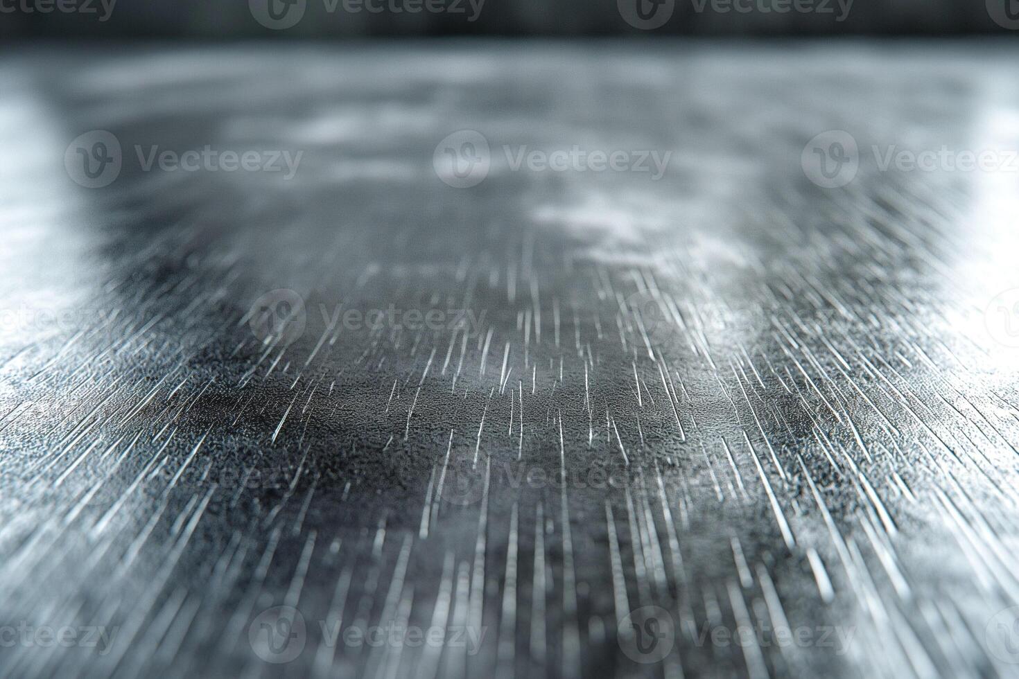 Close-up of a textured metal surface with a shiny, reflective quality, showcasing fine scratches and a sleek appearance. photo