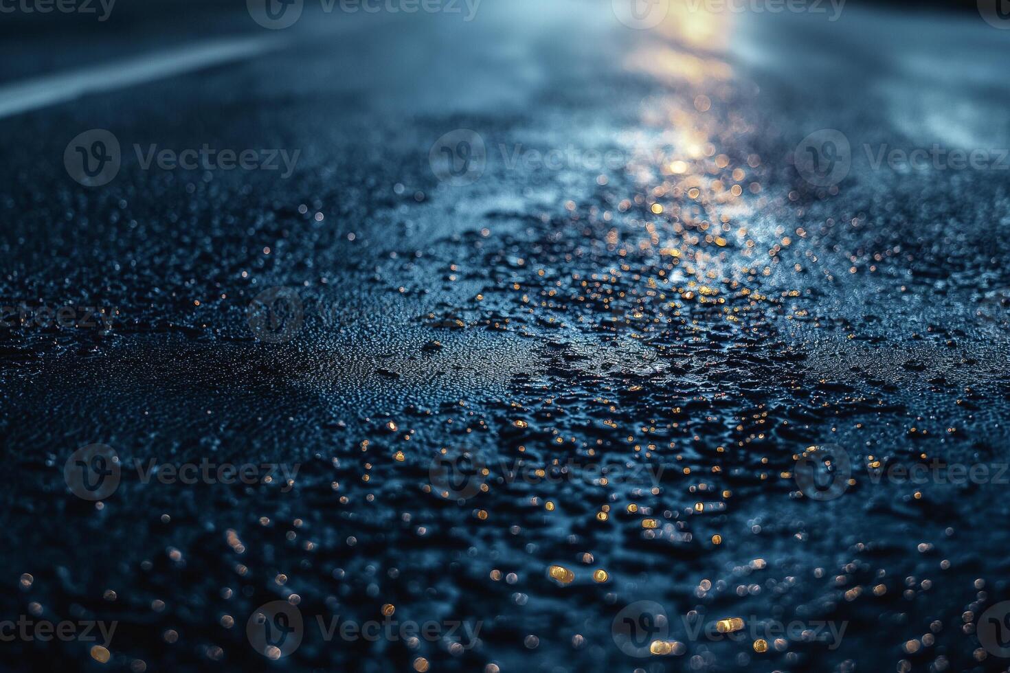 A close-up view of wet pavement glistening under streetlights at night, creating a serene and reflective atmosphere. photo