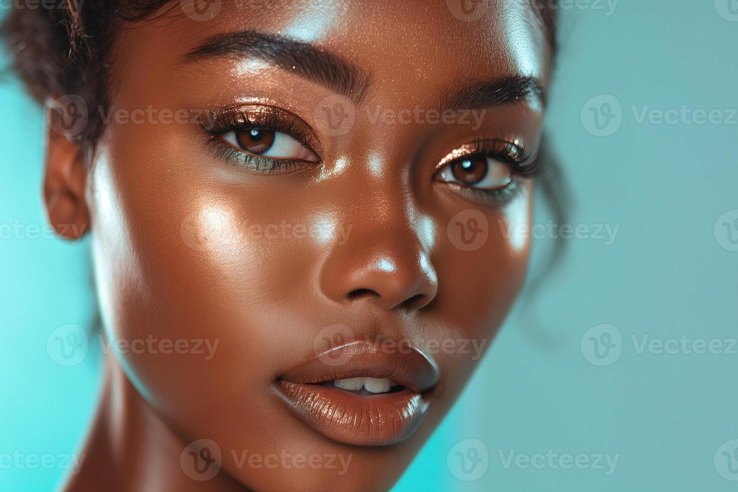 Close-up of a beautiful young Black woman with glowing skin and captivating eyes against a soft blue background. photo