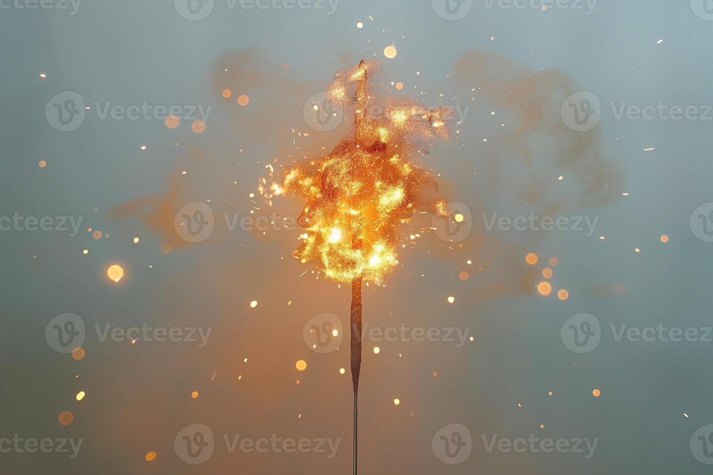 A vibrant sparkler ignites against a misty backdrop, creating dazzling orange and gold sparks that dance in the air. photo