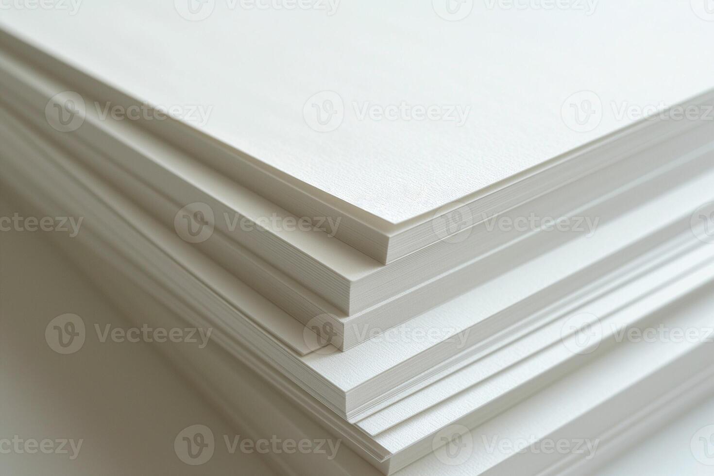 A stack of clean, white sheets of textured paper, showcasing a minimalist aesthetic and perfect for artistic projects. photo