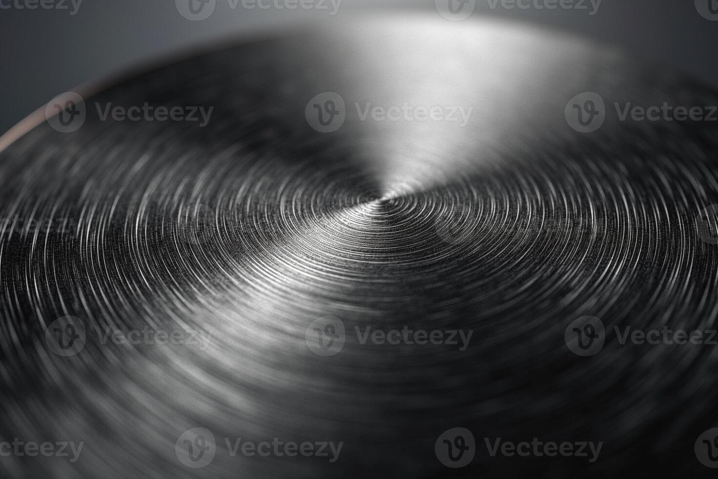Close-up of a polished metal surface with intricate circular patterns, showcasing a sleek and modern aesthetic. photo