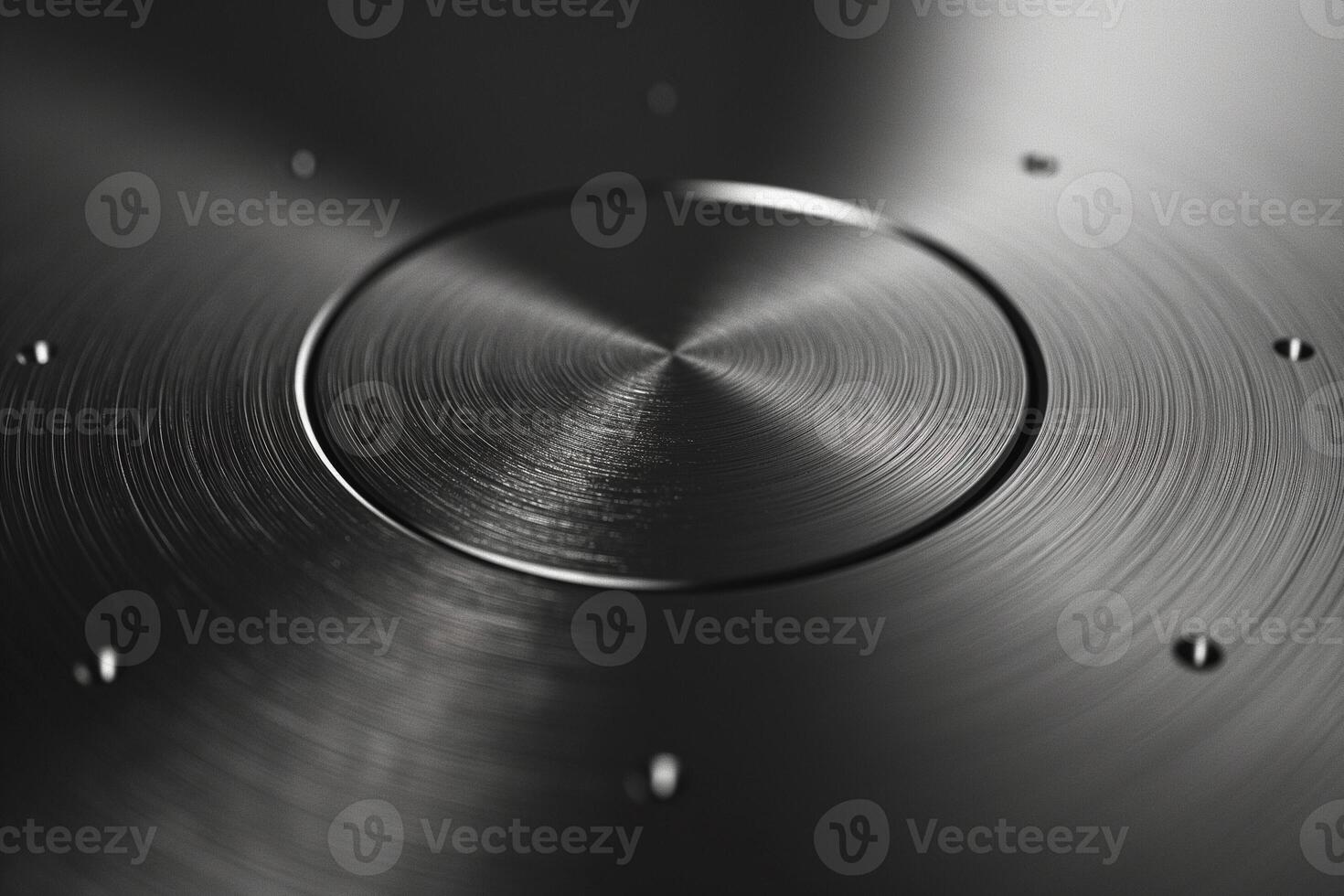 Close-up of a sleek, metallic surface with subtle circular patterns and reflections. photo