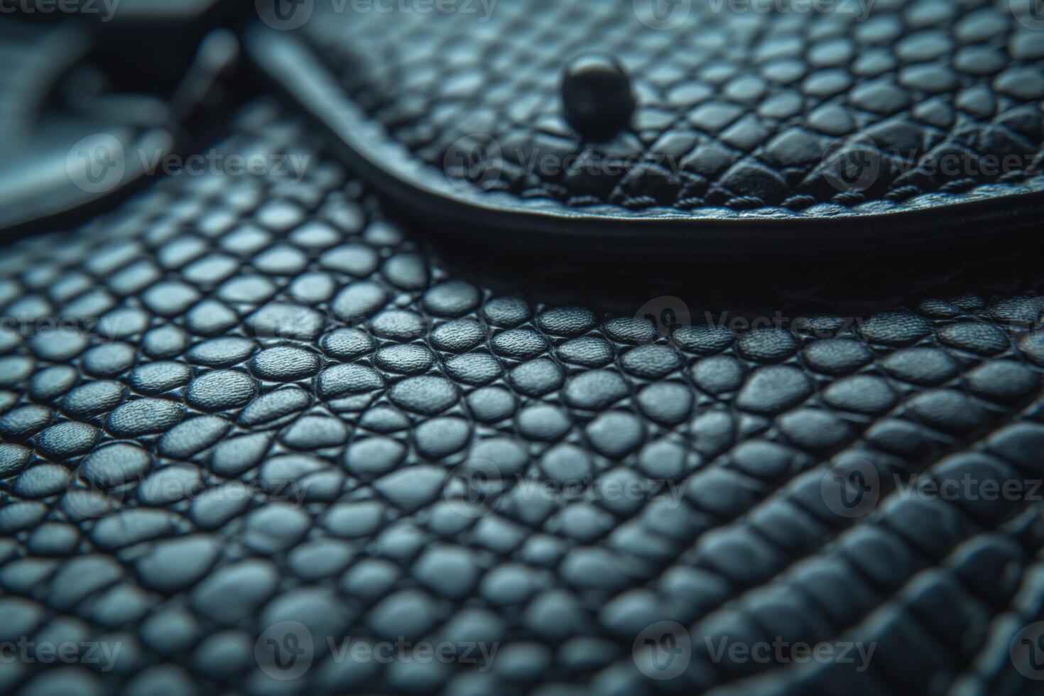 Close-up of a textured black leather surface showcasing intricate patterns and luxurious feel. photo