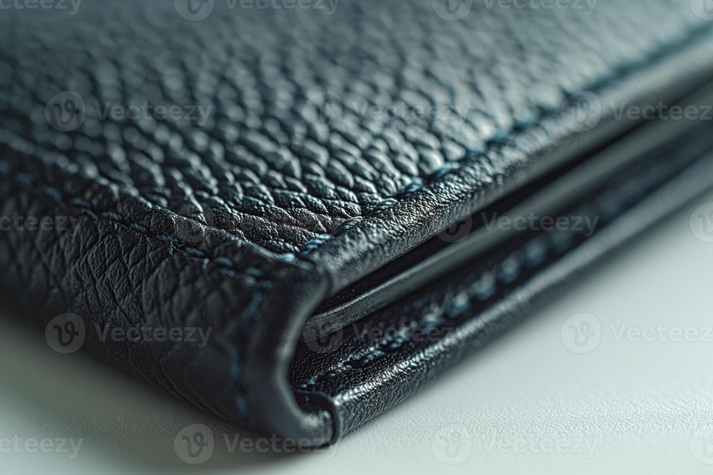 Close-up of a textured black leather wallet showcasing its fine stitching and craftsmanship. photo