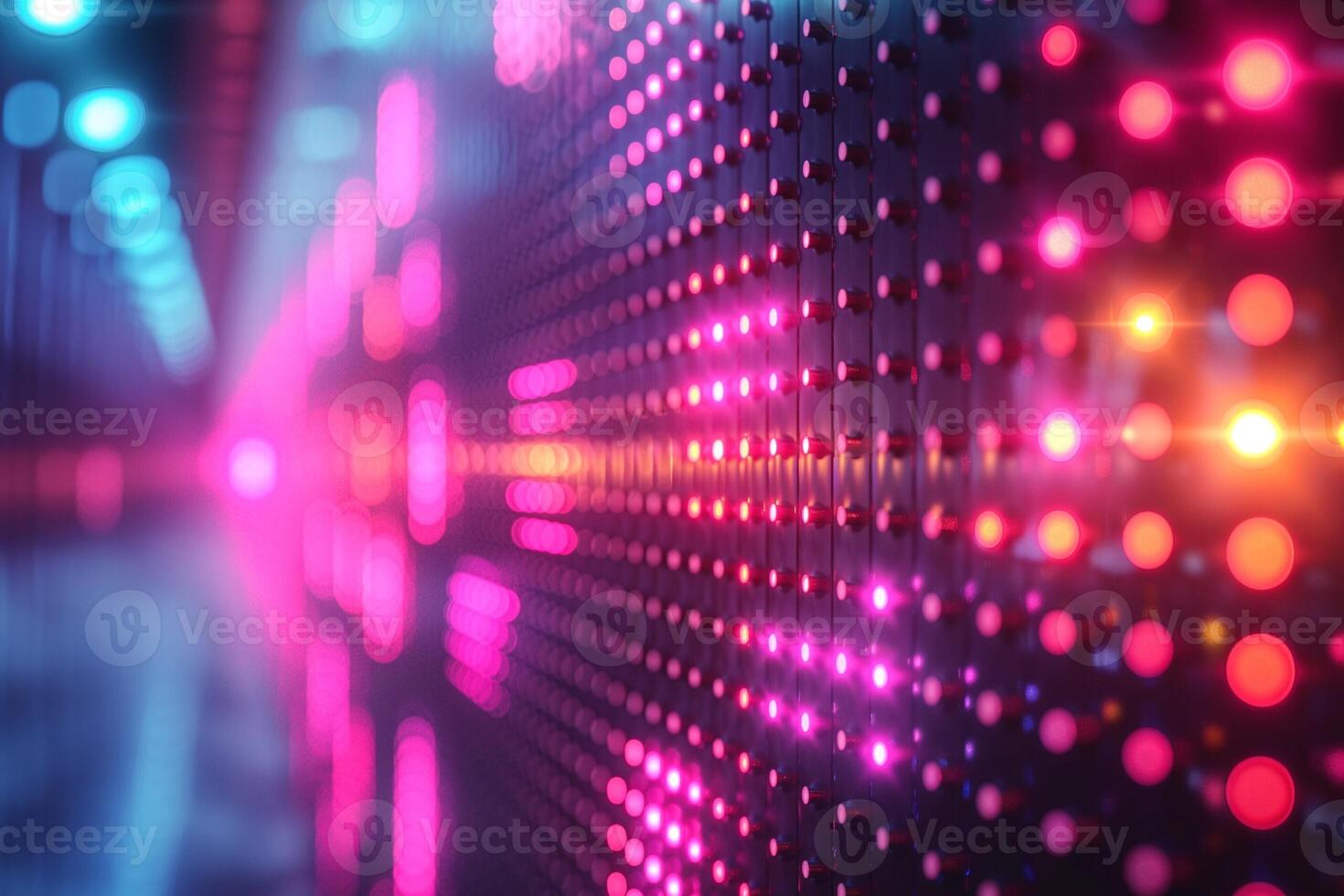 An abstract close-up of illuminated LED lights creating a vibrant pattern in shades of pink, blue, and purple. photo