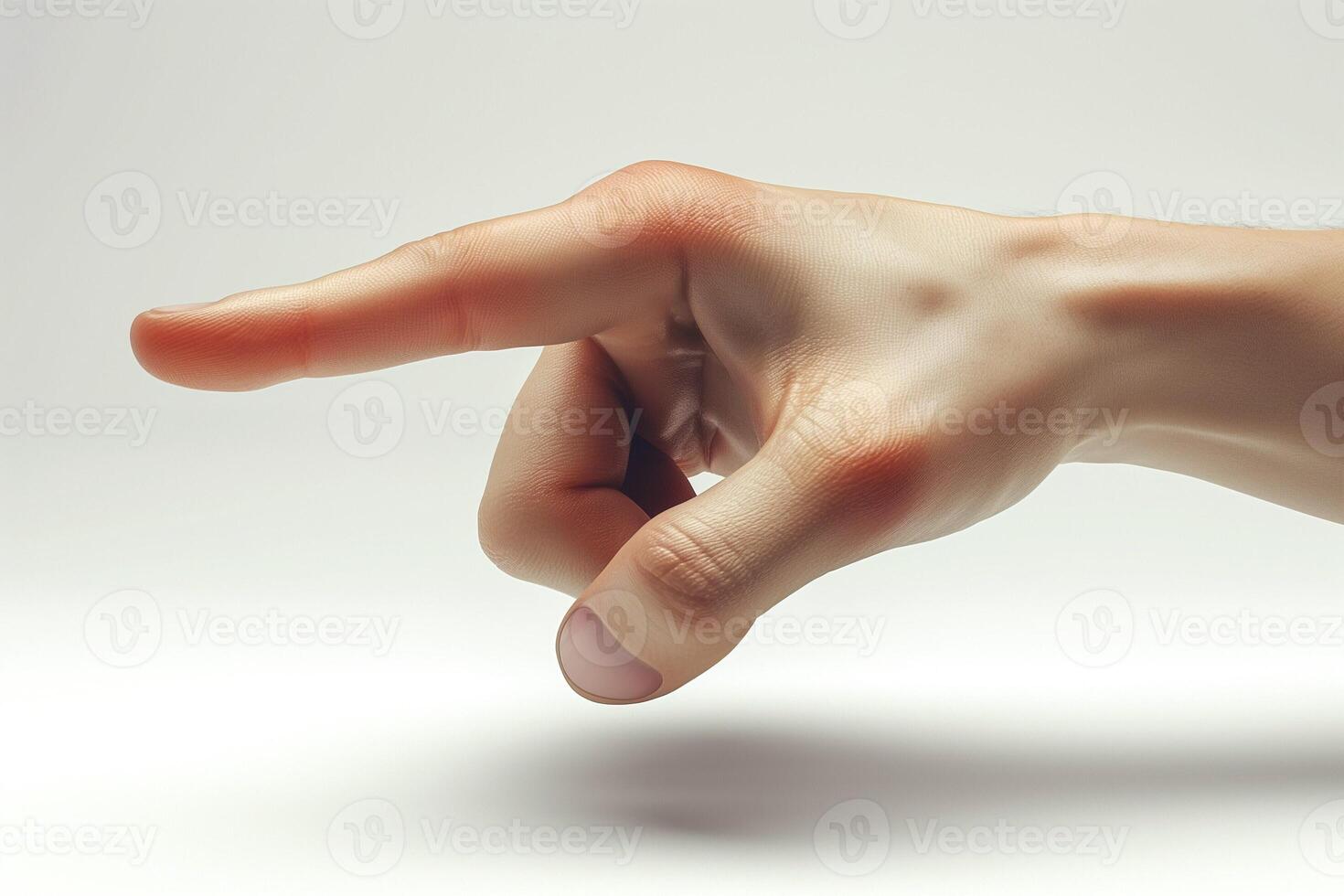 A close-up of a Caucasian male hand pointing with a relaxed posture against a soft, neutral backdrop. photo