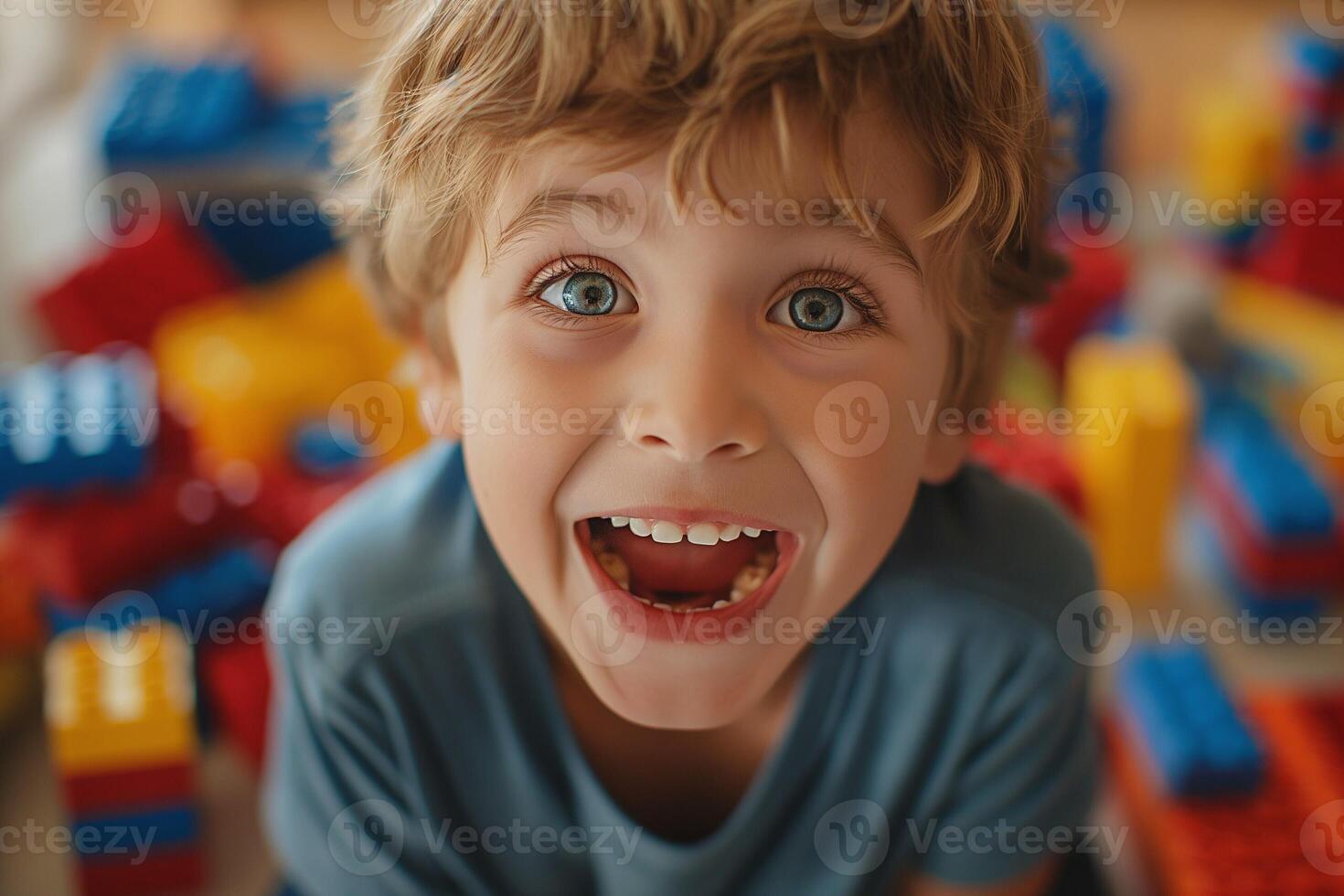 A joyful Caucasian boy playing with colorful building blocks, showcasing his excitement and happiness. photo