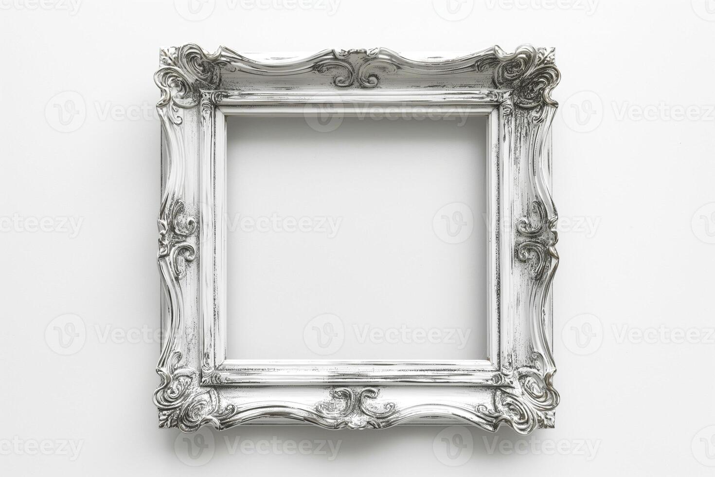An ornate, vintage-style empty picture frame in white, showcasing intricate designs and giving a classic touch. photo