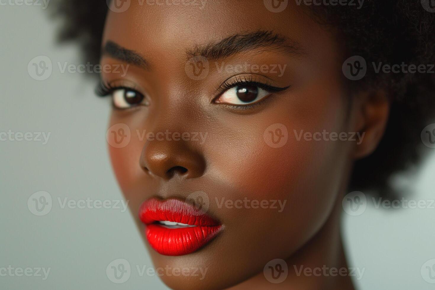A close-up portrait of a Black woman with striking red lips and defined eyeliner, exuding confidence and beauty. photo