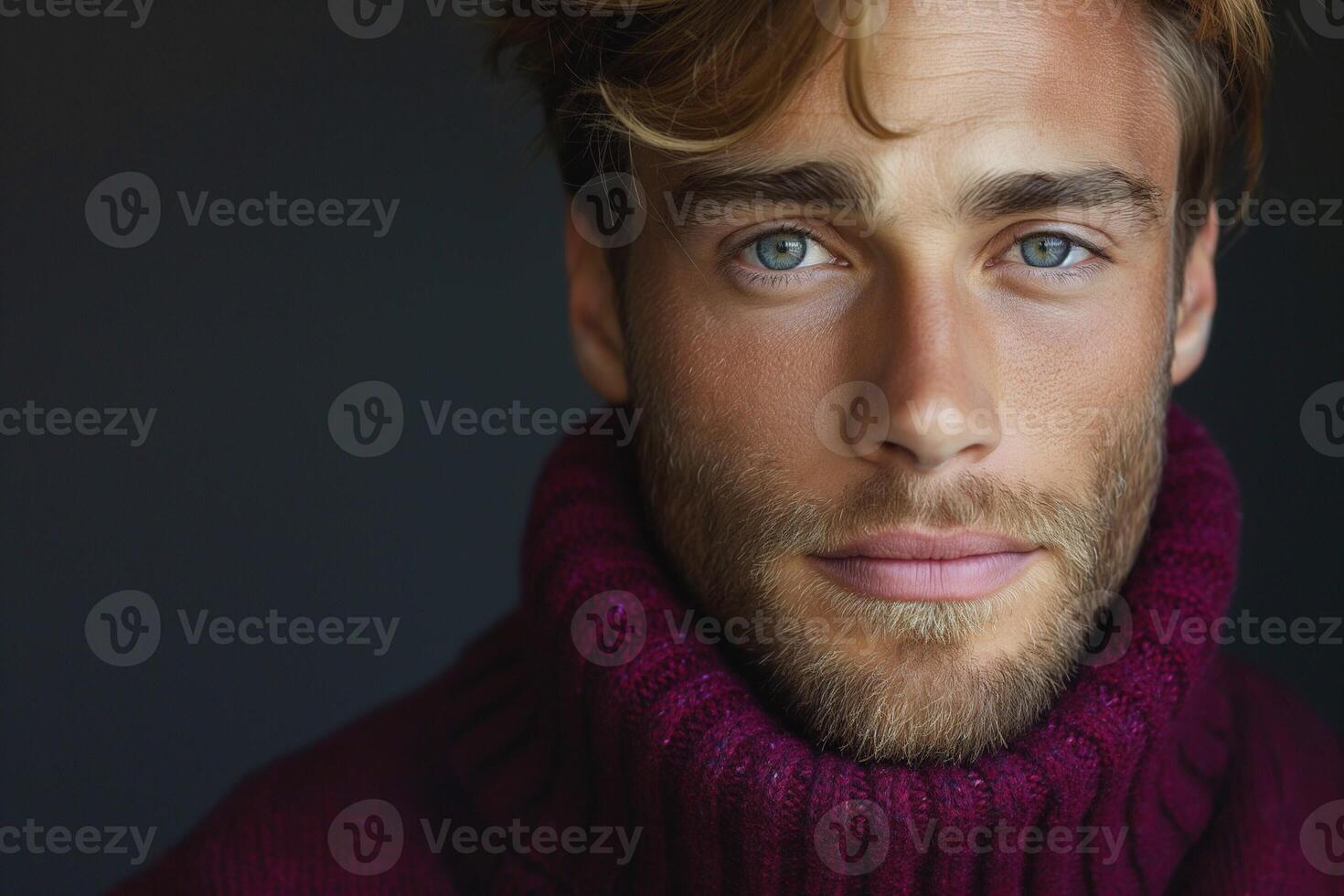Close-up shot of a handsome Caucasian man with striking blue eyes wearing a turtleneck sweater. photo