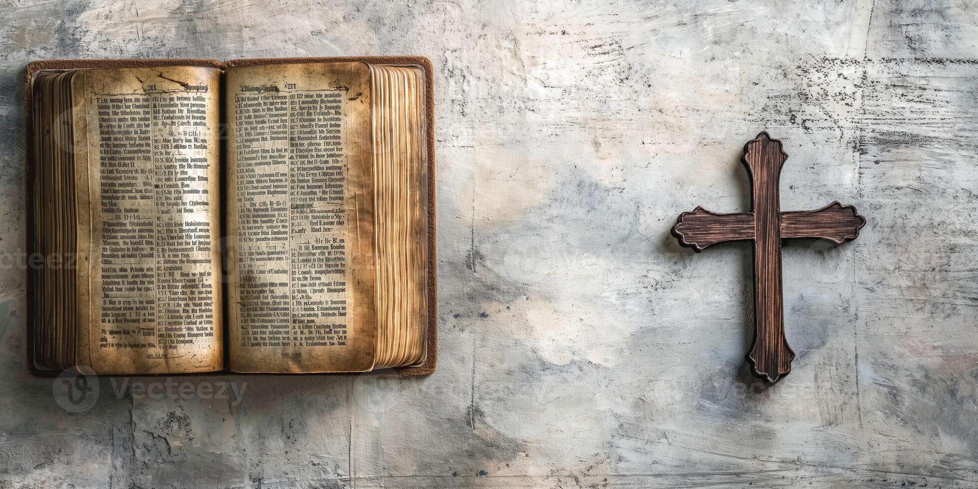 An open vintage book beside a wooden cross, symbolizing faith and spirituality in a serene setting. photo