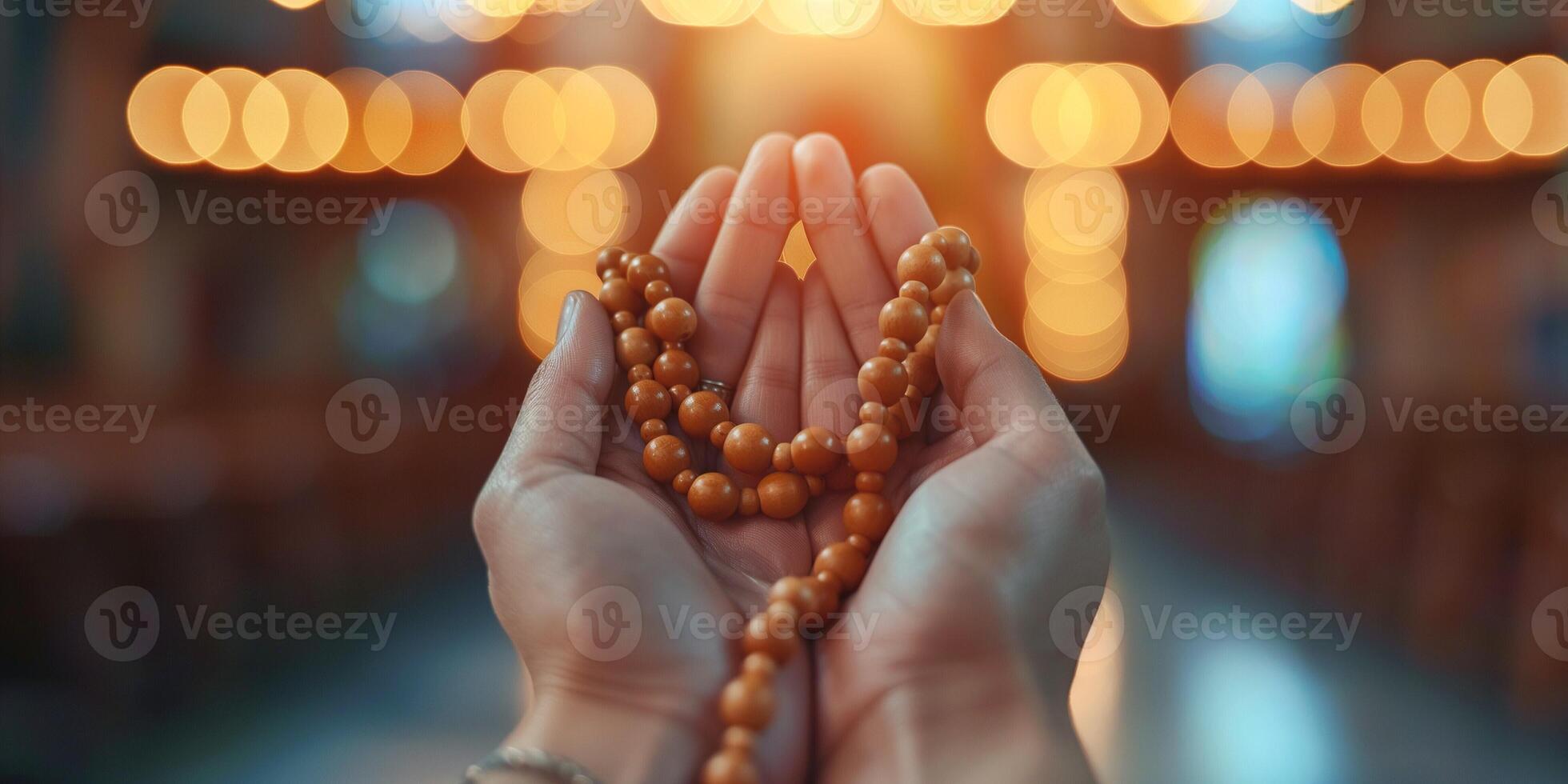 A close-up of a person's hands, showcasing prayer beads with a warm, glowing background, evoking a serene and spiritual atmosphere. photo