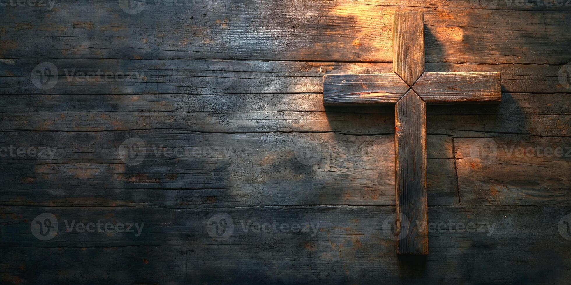 A rustic wooden cross illuminated softly against a dark, textured background, evoking a sense of reverence and tranquility. photo