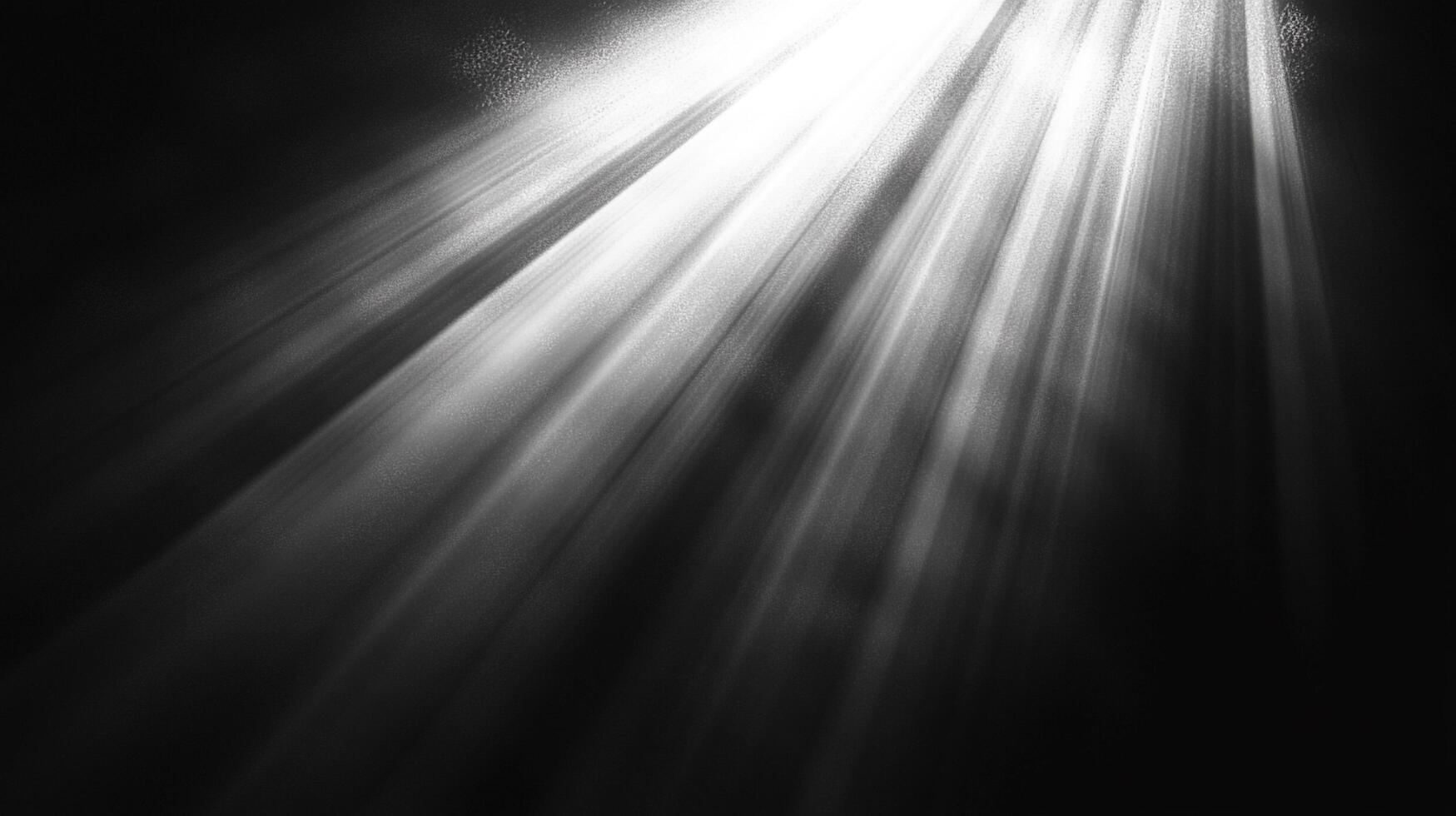 Striking black and white image featuring radiant light beams cutting through darkness, creating dramatic contrast and highlighting textures. photo