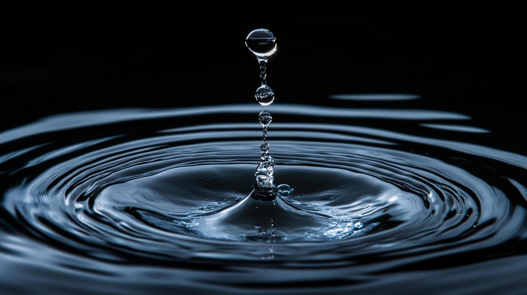 Captivating water droplet photography showcasing the beauty of water and wave patterns in high-speed detail, set against a dark backdrop. photo