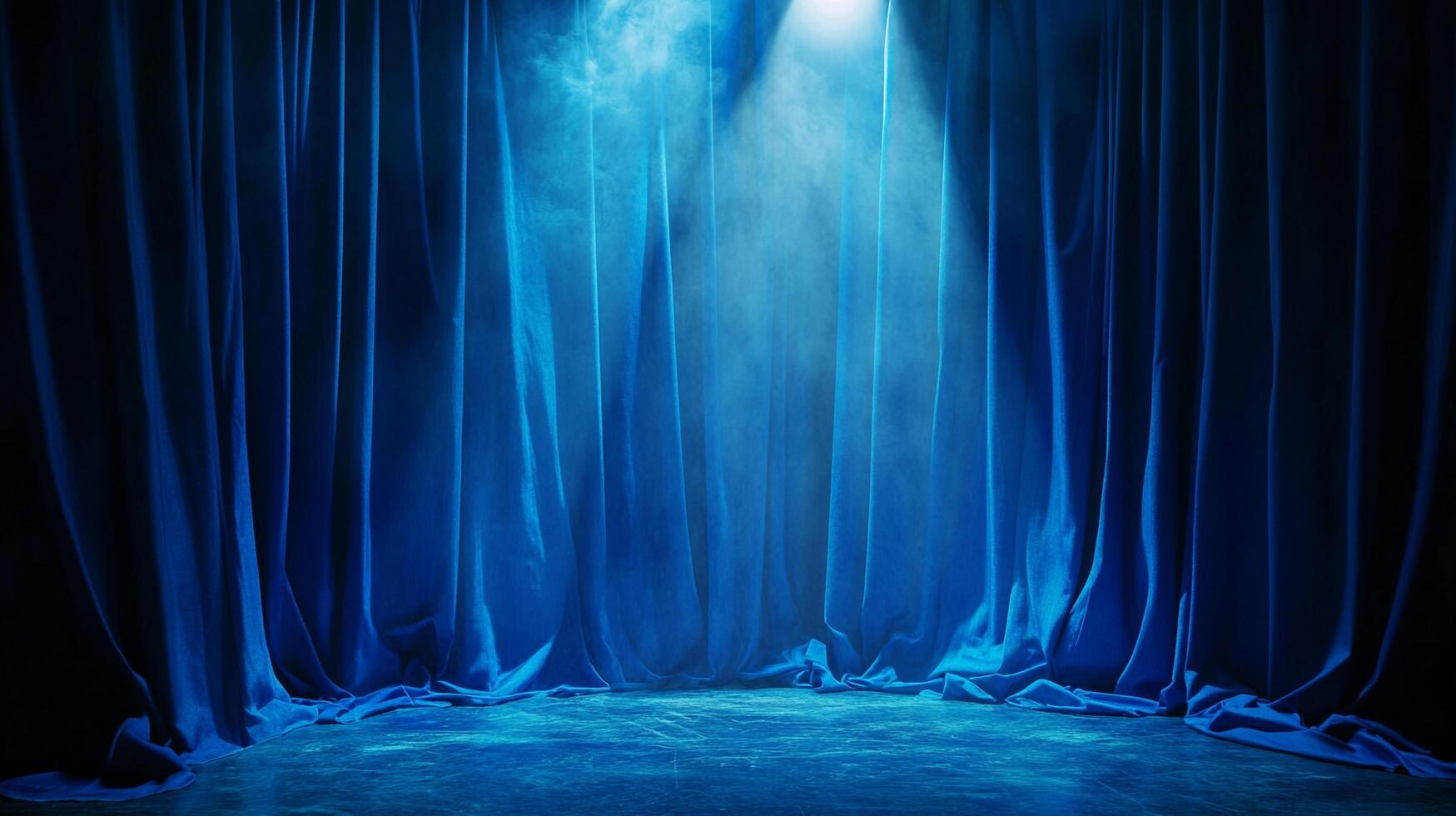 Dramatic blue stage curtains illuminated by a spotlight, creating an atmosphere of anticipation for a performance or event. photo