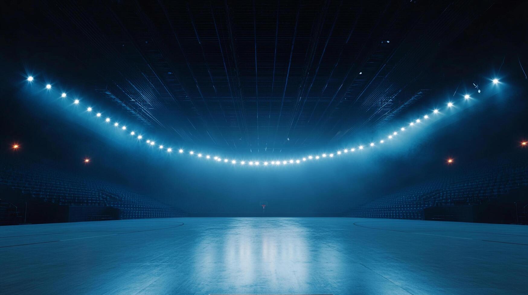 A low angle view of a sports arena with a polished floor and stadium seating, highlighted by bright, evenly spaced lighting. photo