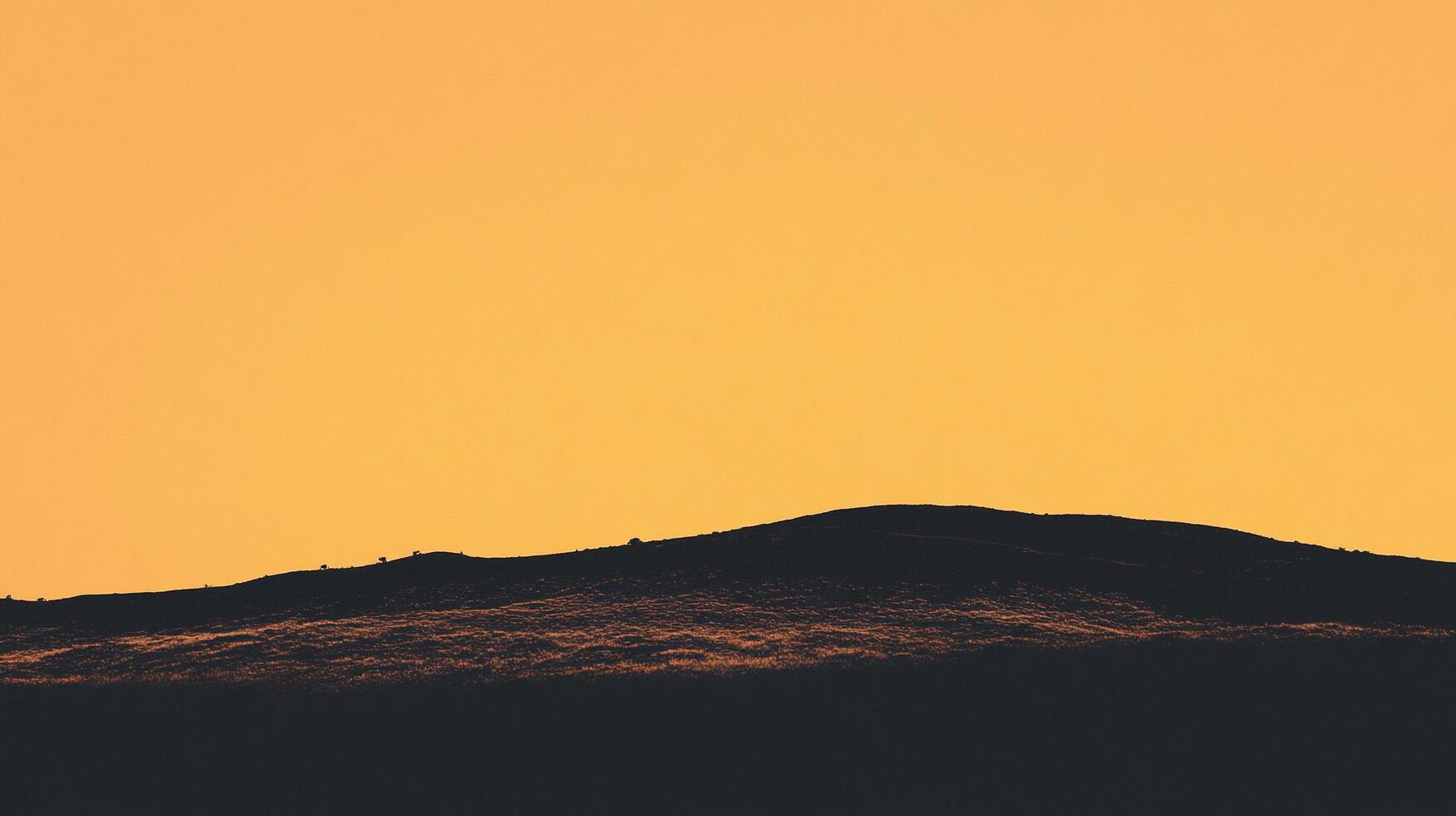 Serene view of a dark rolling hill beneath a vibrant yellow sky. A minimalist, natural scene evoking peace and tranquility. photo