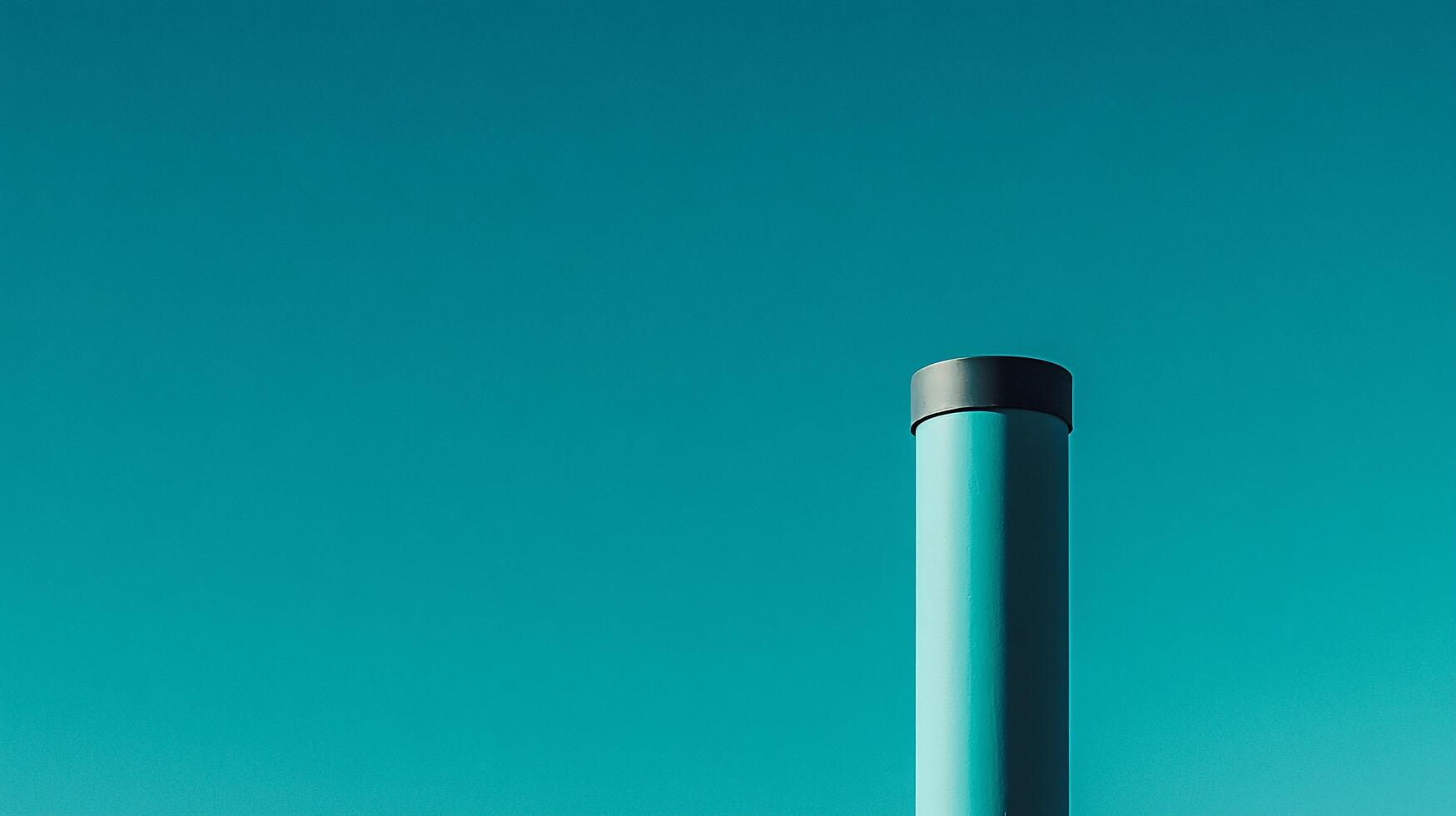 Cylindrical object stands out against a tranquil blue sky. Simplicity and minimalism create a visually arresting composition. photo