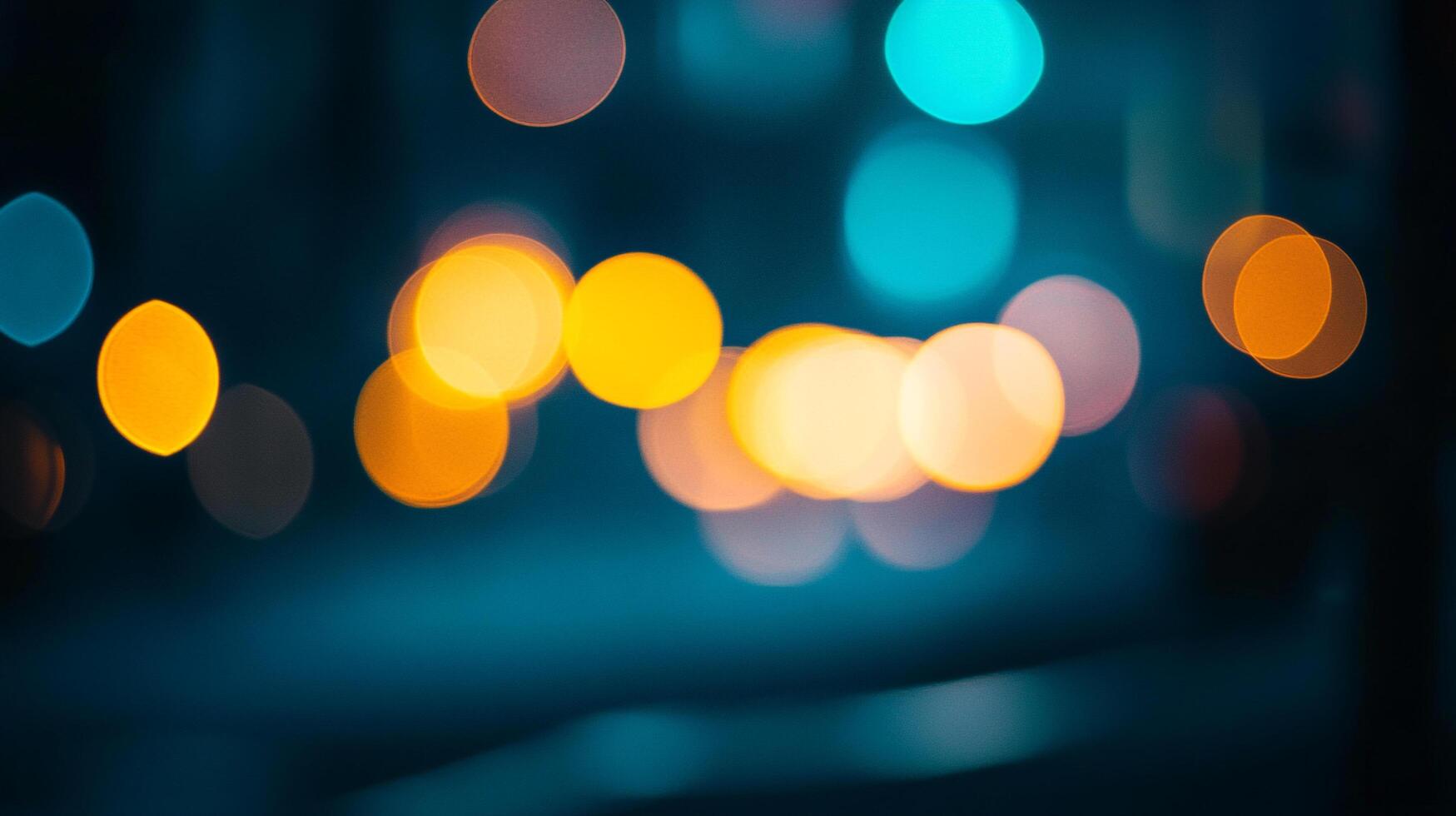 Abstract of street lights showing bokeh. Night time photography with glowing lights. The vibrant colors are on a dark teal background. photo