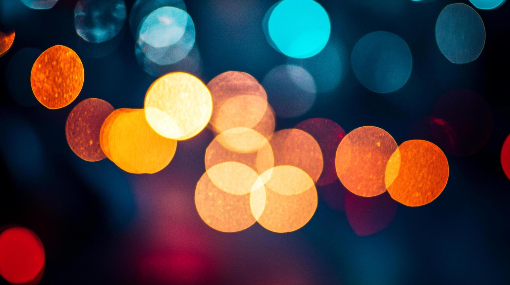 Abstract lights at night create a festive, warm, and vibrant atmosphere with orange, blue, and red hues on a dark backdrop. photo
