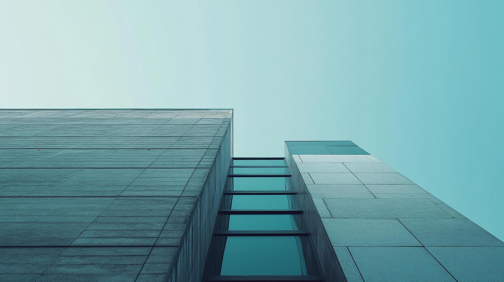 Abstract architectural shot showcasing converging building structures reaching towards a uniform, light teal sky. Modern aesthetics. photo