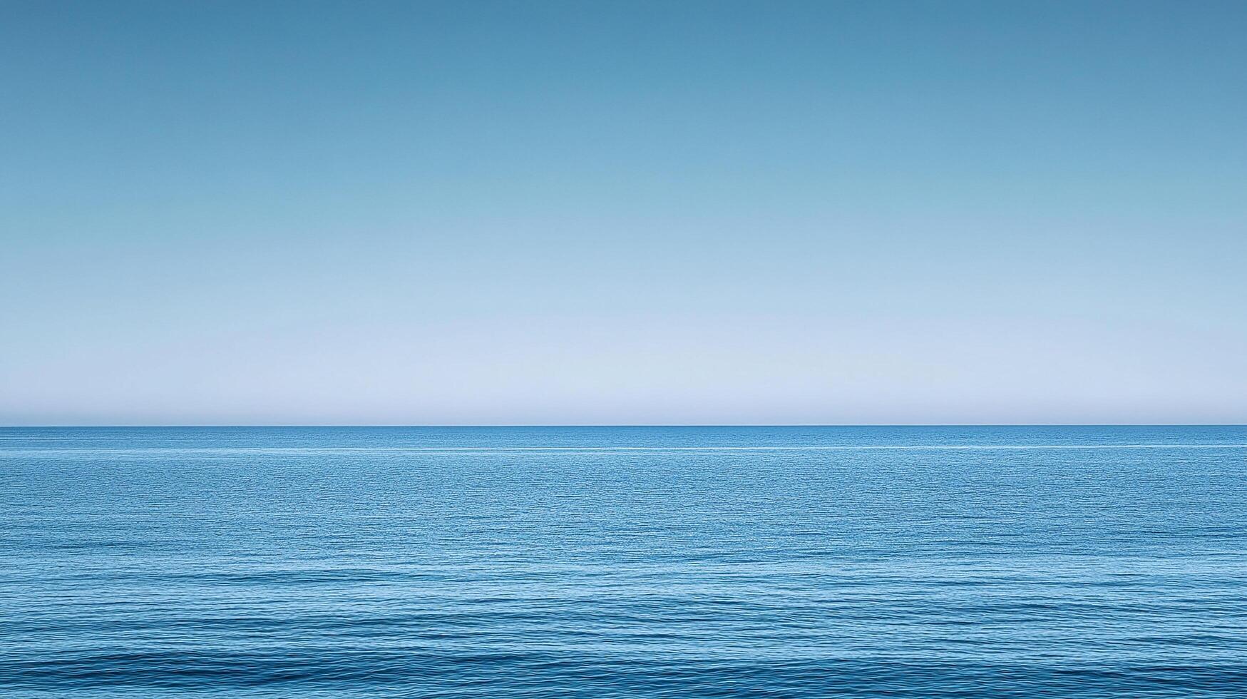Calm blue ocean meeting a clear sky horizon, showcasing peacefulness and serenity with subtle wave patterns in a tranquil seascape. photo