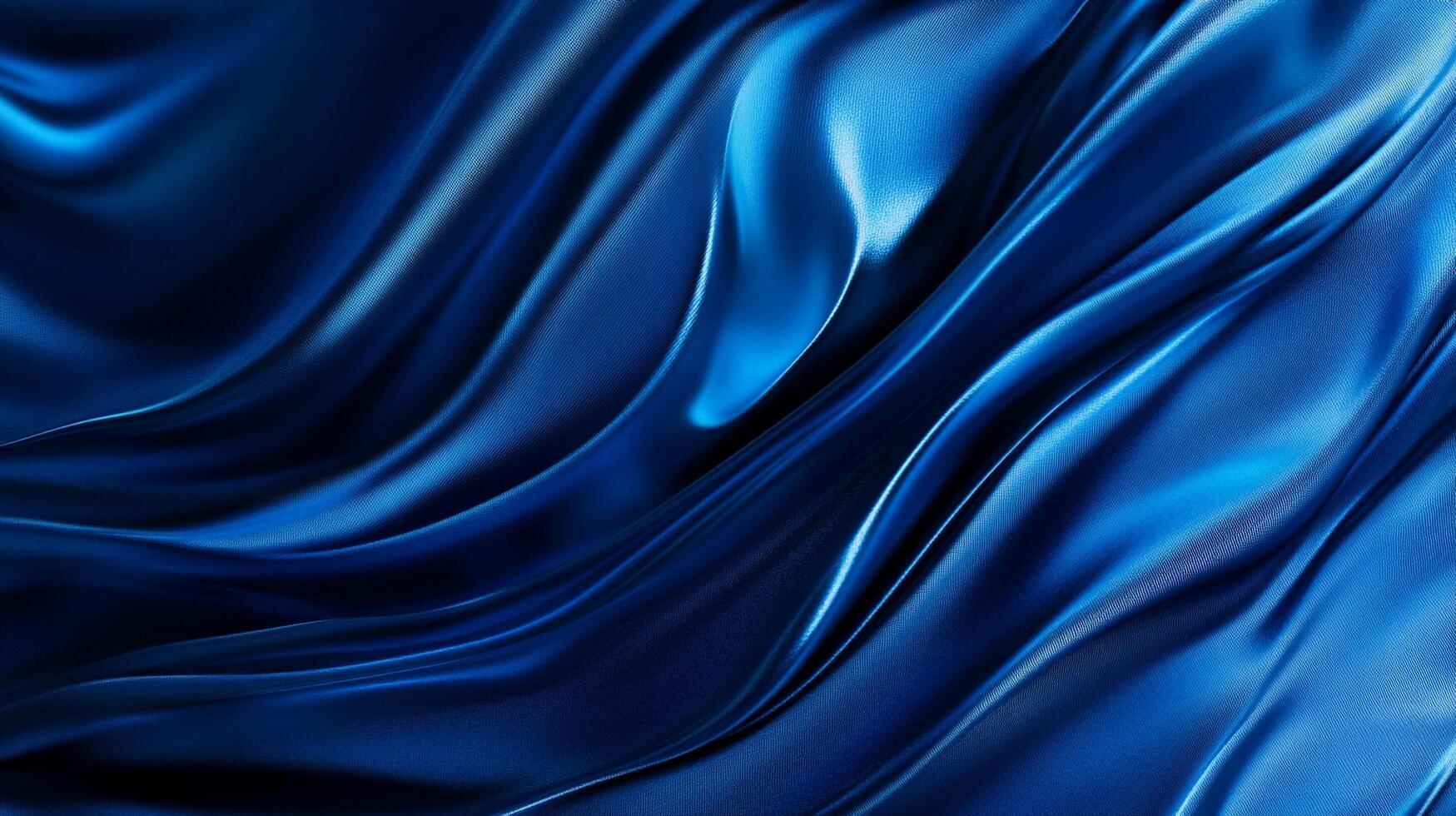 A captivating display of flowing deep blue fabric, creating a mesmerizing play of light and shadow on the textured surface. photo