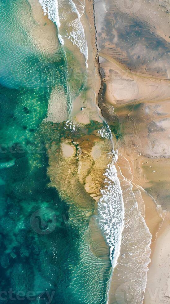 Aerial view of beach with crashing waves and natural landscape photo