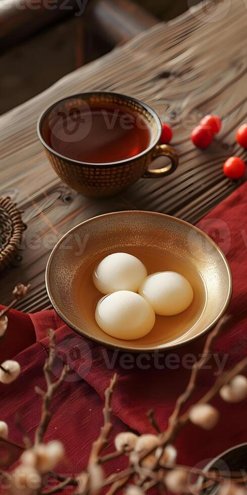 Food dish of rice balls and tea arranged on wooden table photo