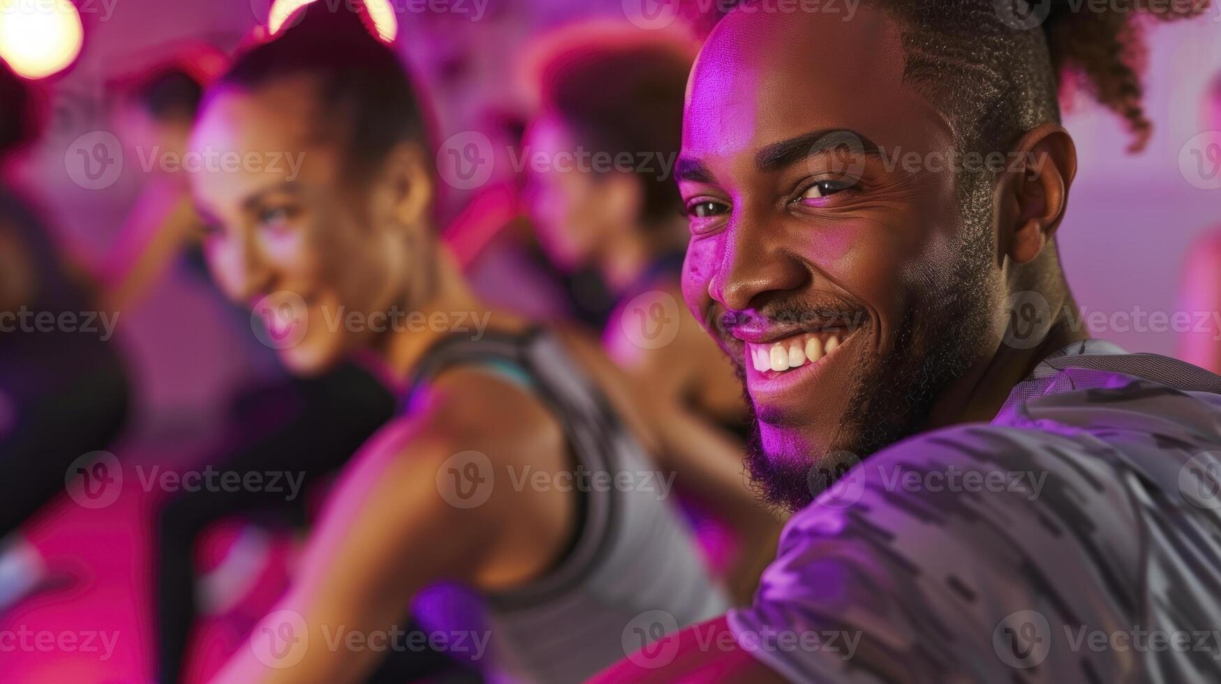 A man smiles while doing a zumba class photo