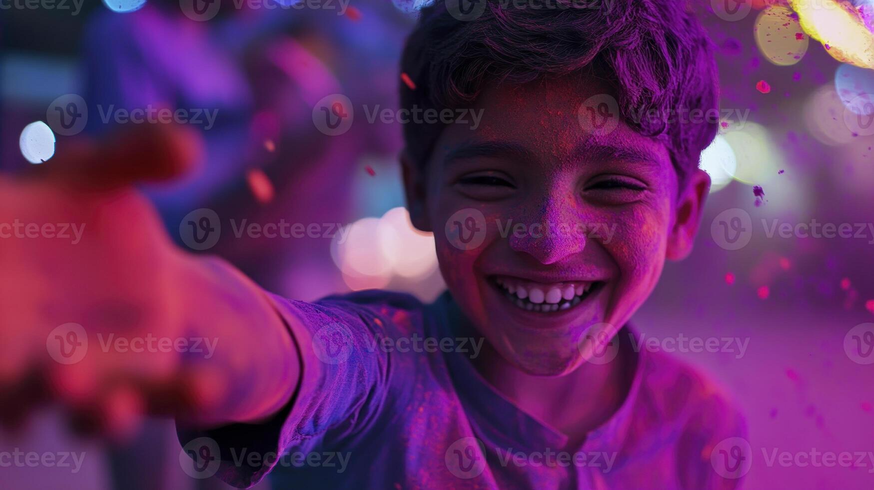 A boy is smiling while holding a paint pot photo