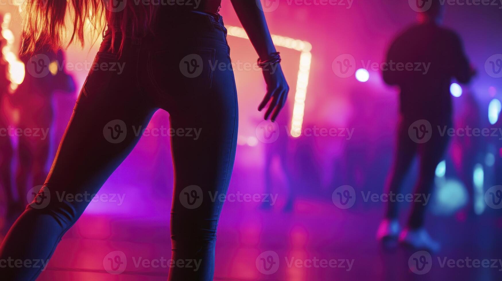A woman in a tight pants standing in front of a crowd photo