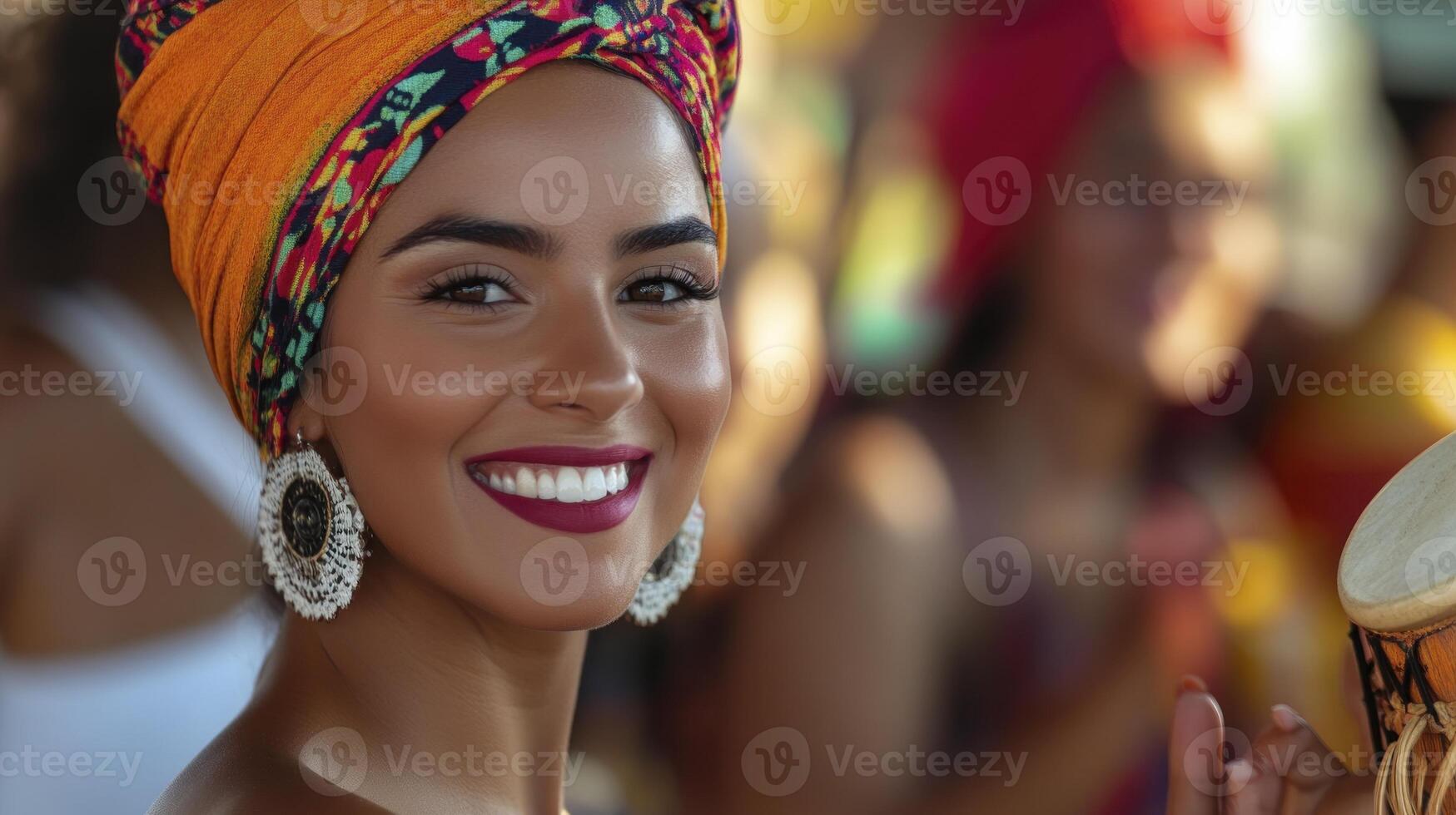 A woman in a colorful headscarf is smiling while holding a drum photo