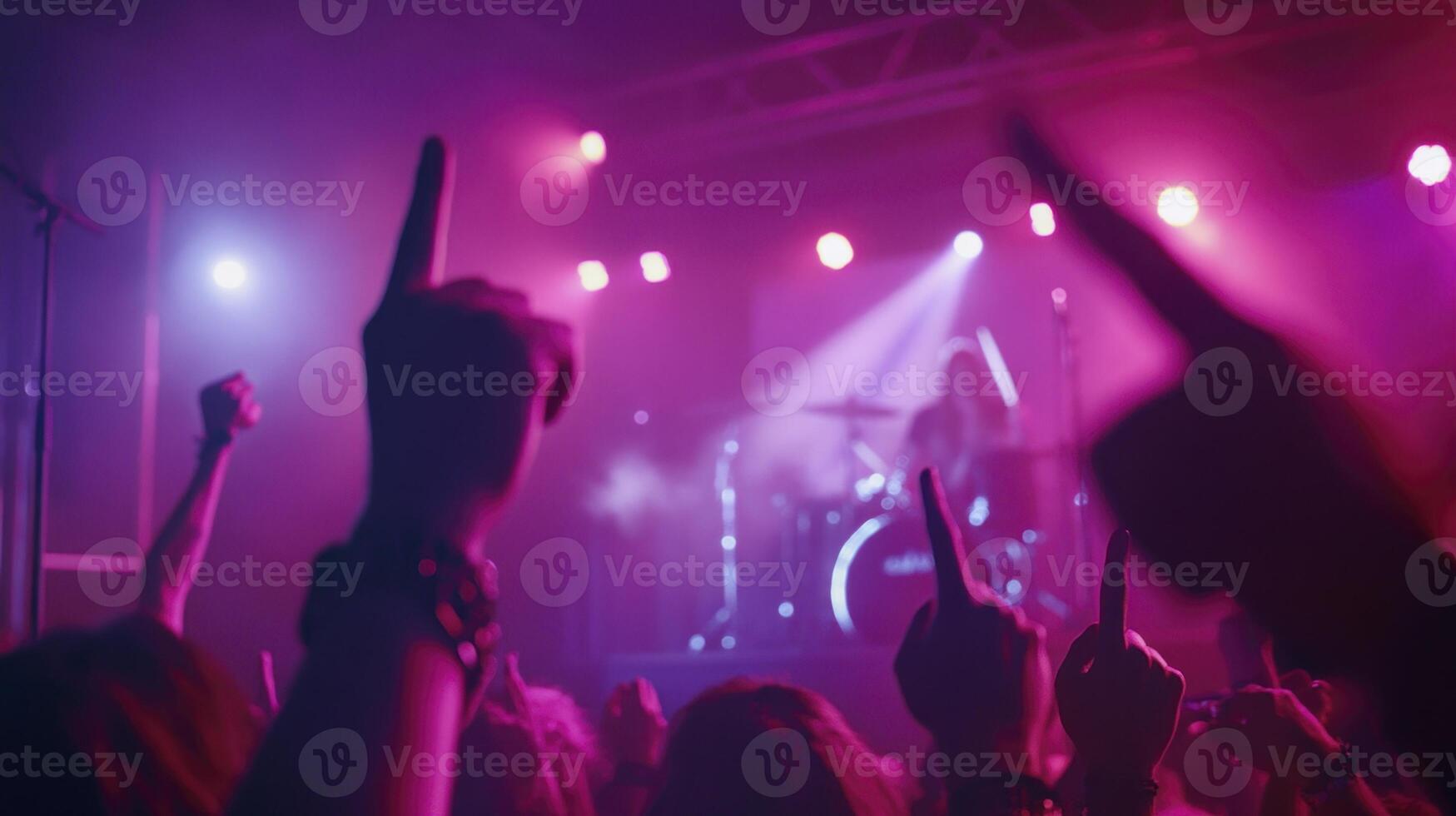 People at a concert with their hands up photo
