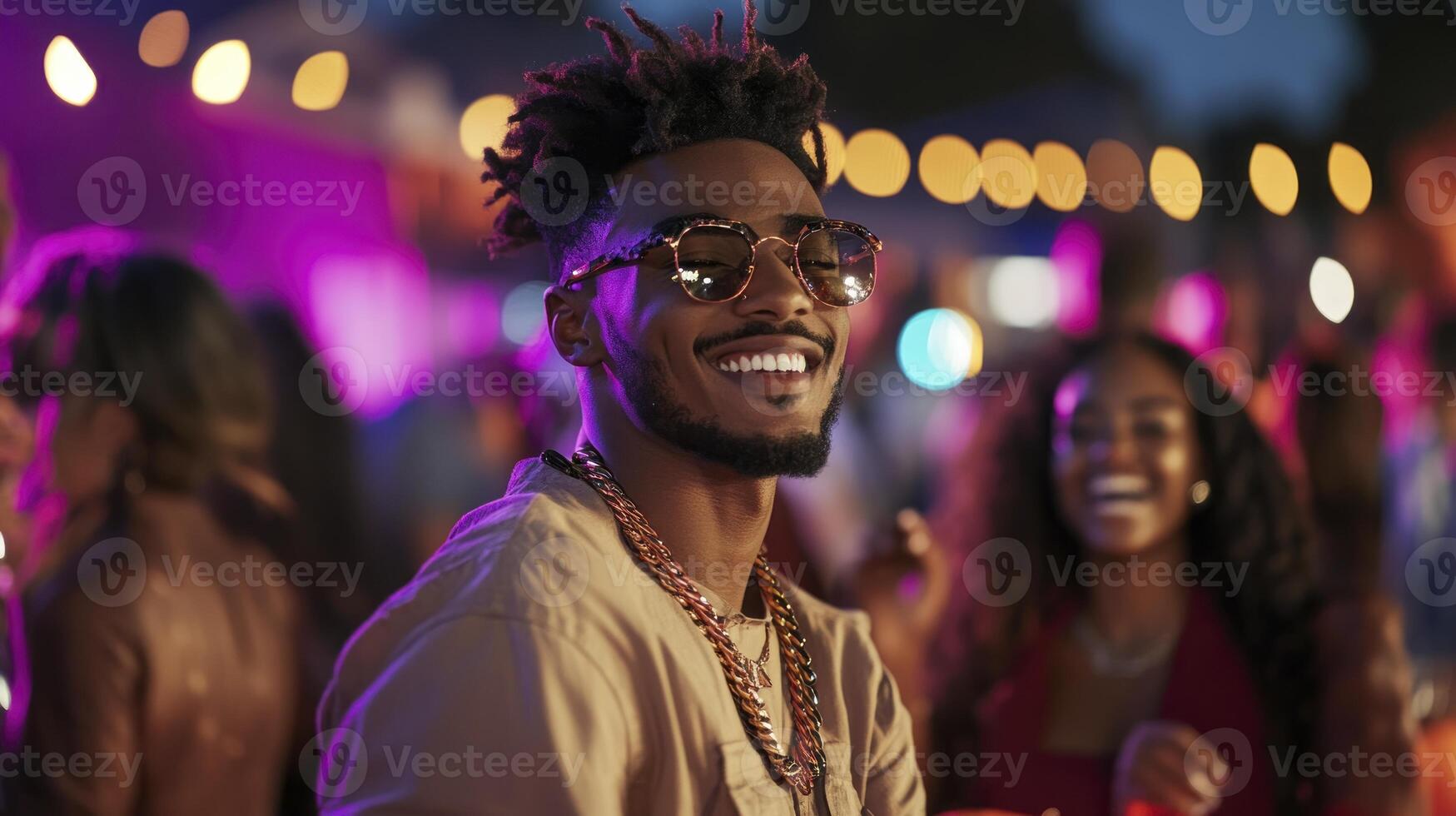 A man with dreadlocks and sunglasses at a party photo