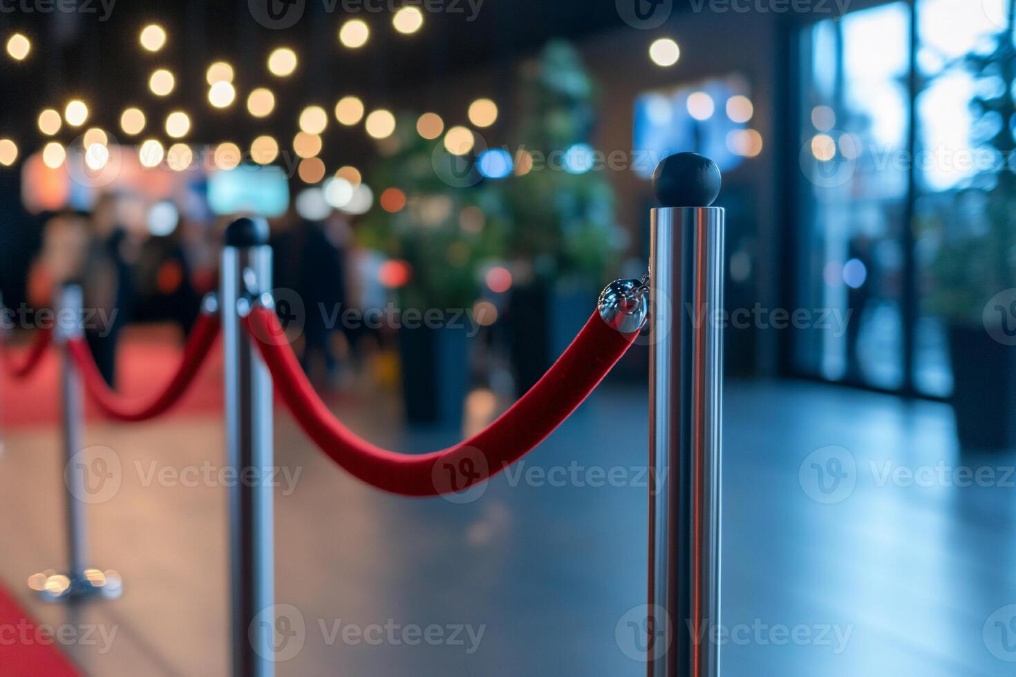 Red rope barriers and red carpet at an event photo
