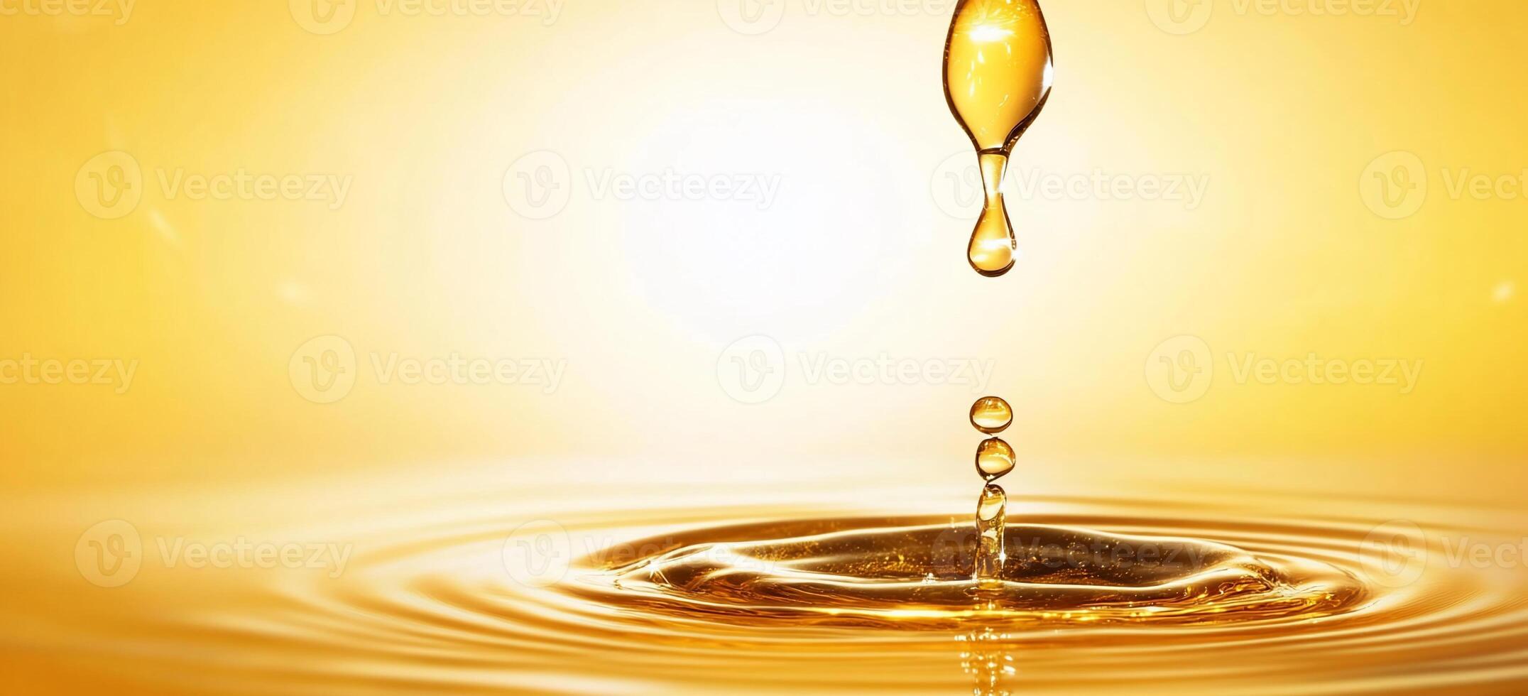 A drop of oil is falling into a pool of water photo