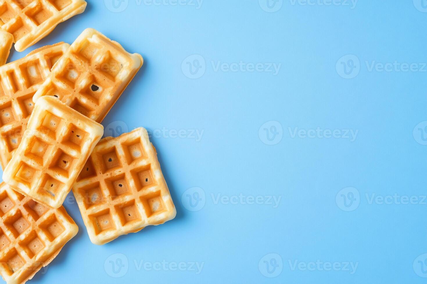 A collection of waffles on a blue background, ready to be served. photo