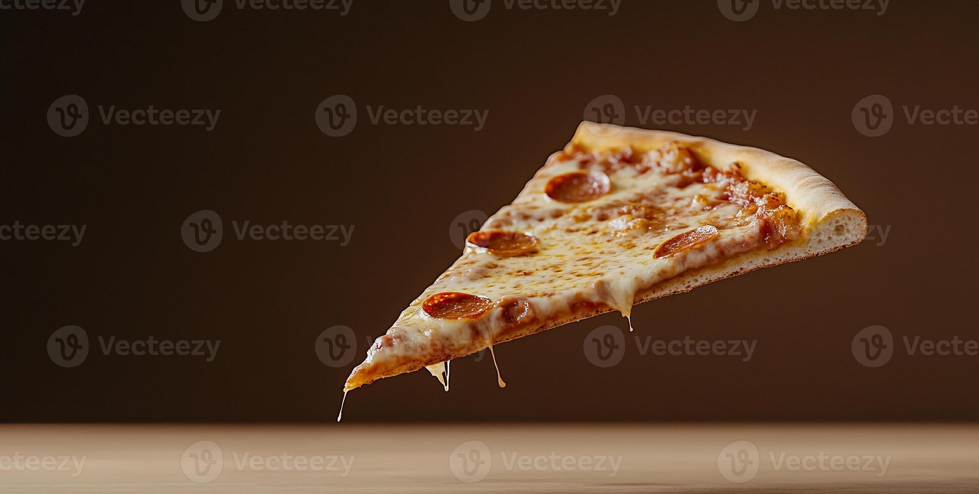 A slice of pizza with cheese and pepperoni, floating against a dark background. photo