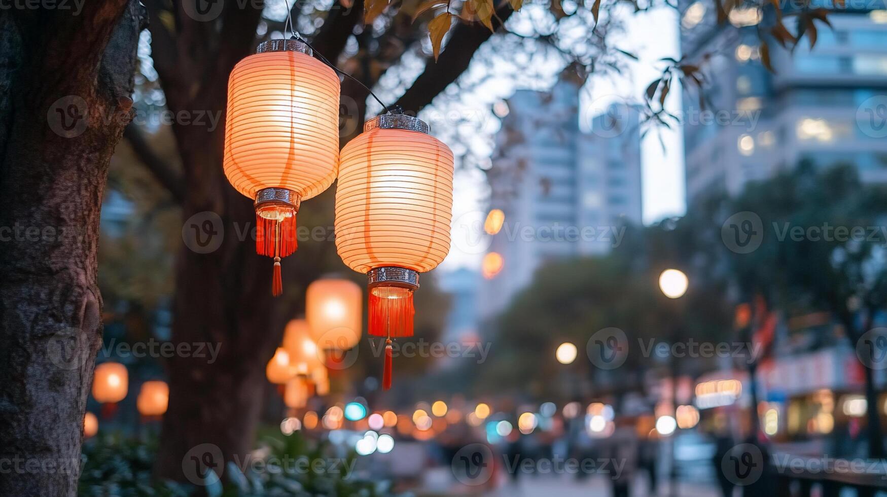 Lanterns glow softly in an urban setting during twilight. photo