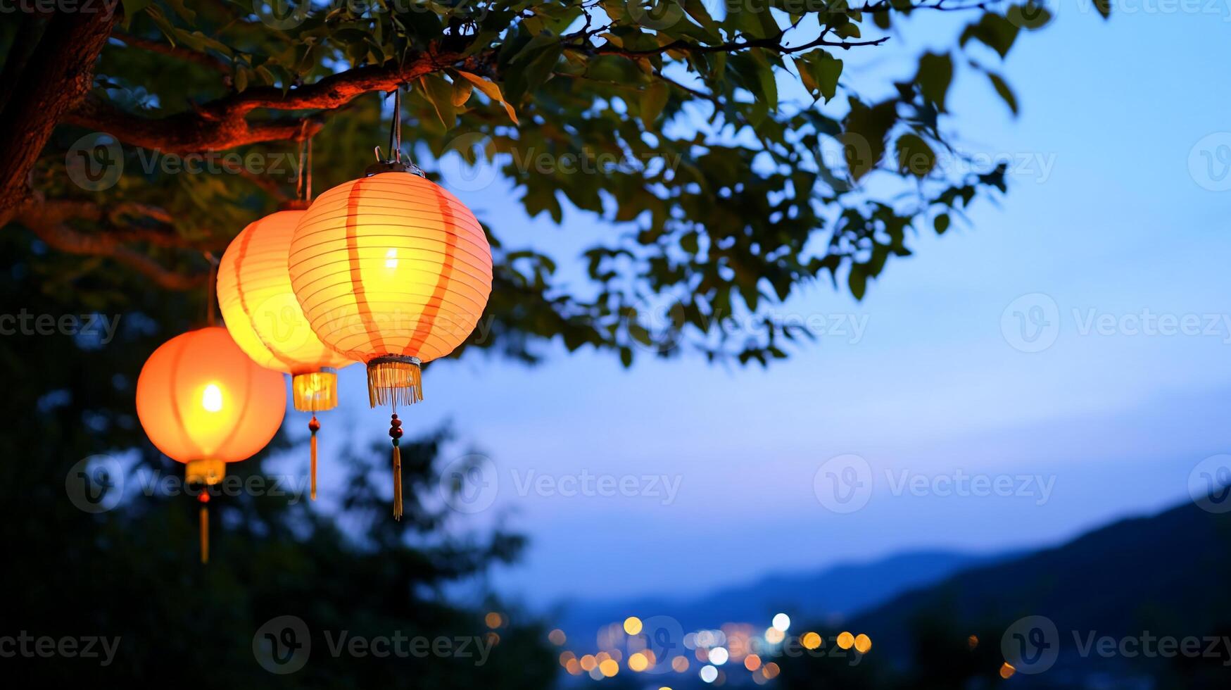 Three glowing lanterns hanging from a tree at dusk, creating a serene atmosphere. photo