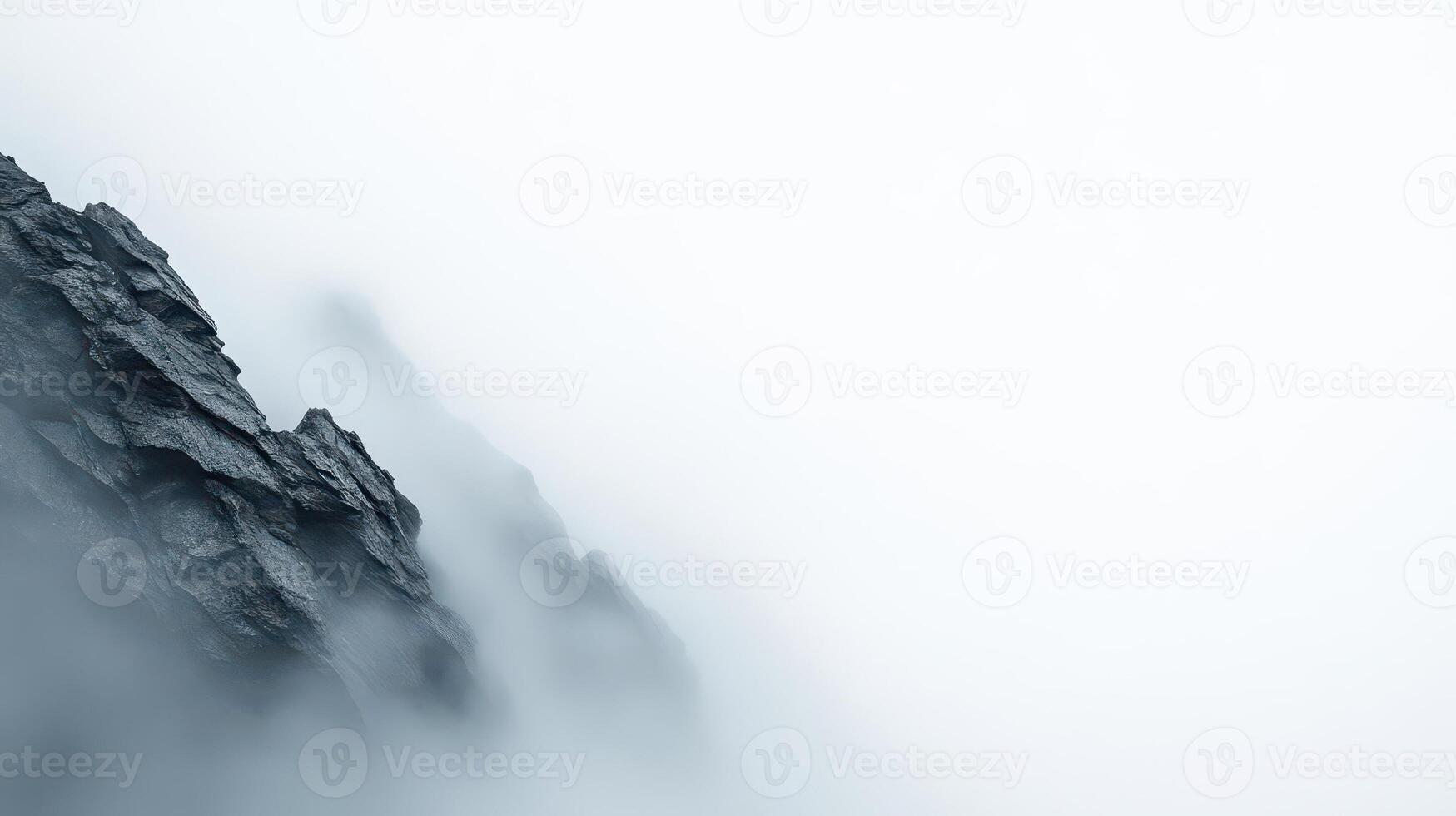Monochrome mountain silhouette against a deep foggy sky, soft light, dramatic mood. photo