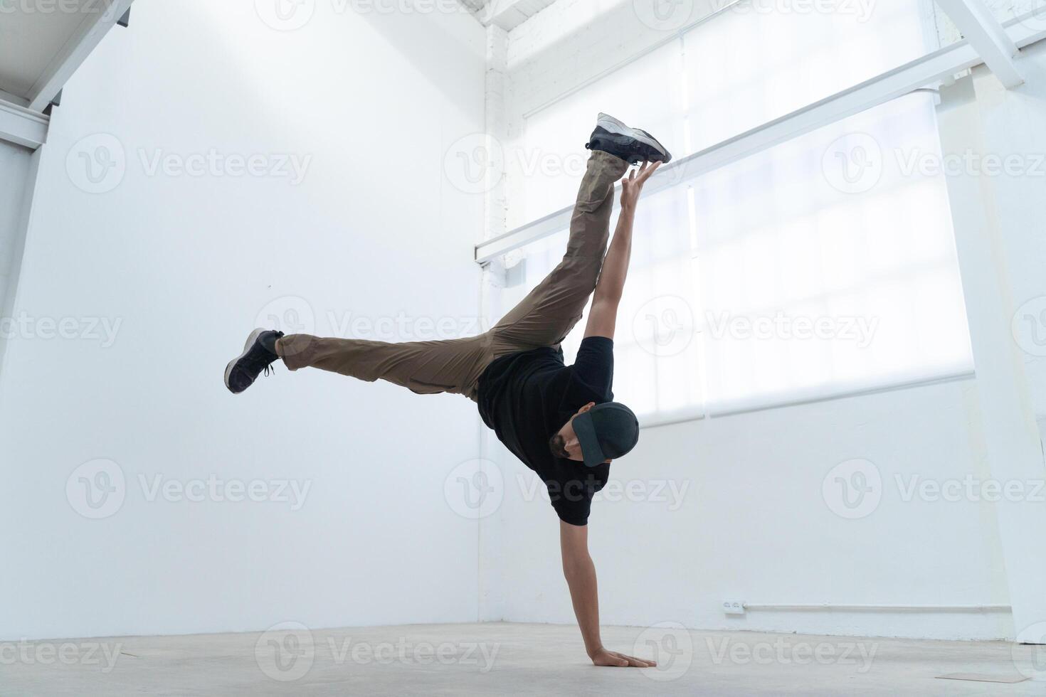 Happy dancing man enjoy practice break dance freestyle dance in building. Professional b-boy dancer photo