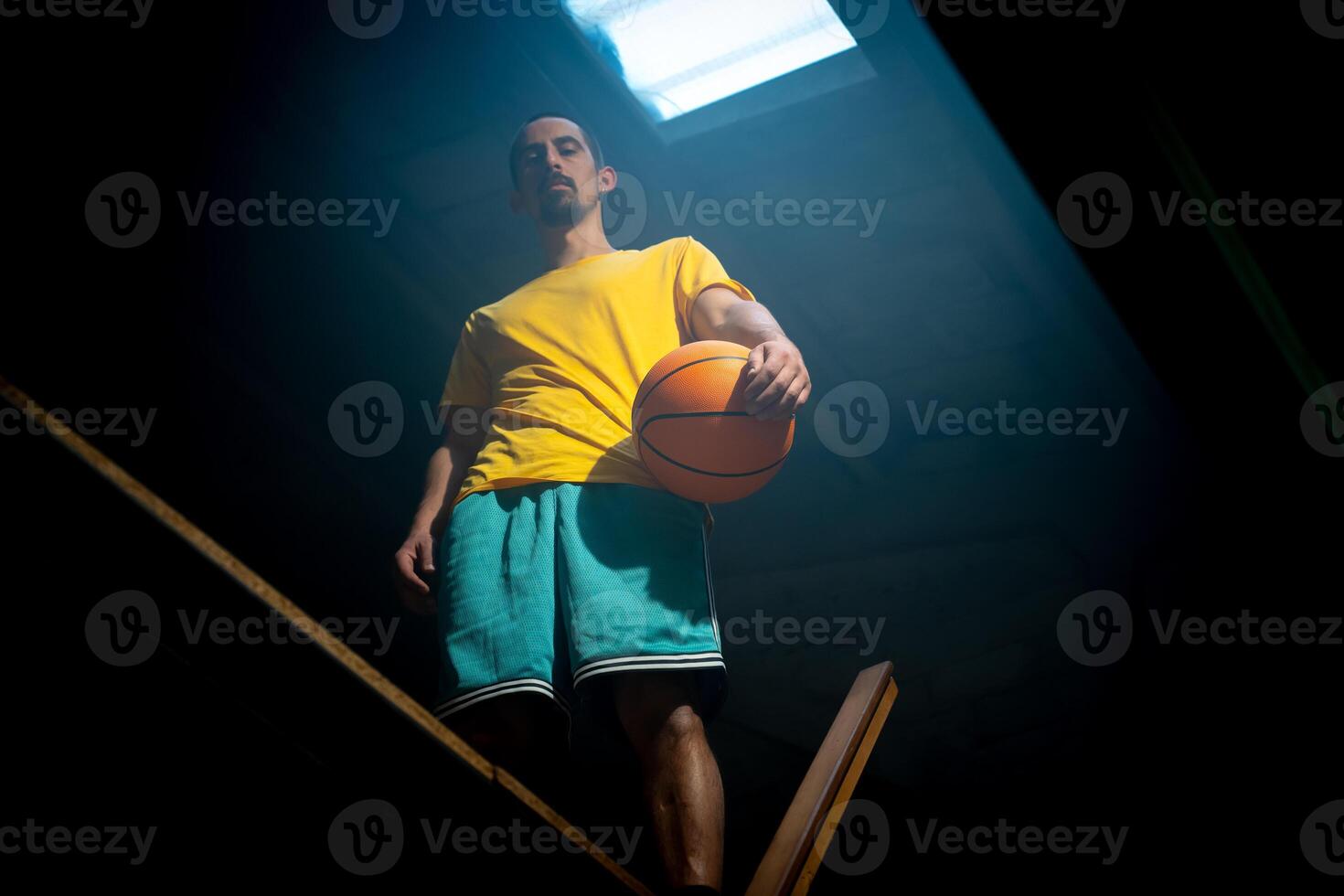 A basketball player intensely focused in dramatic and captivating lighting photo