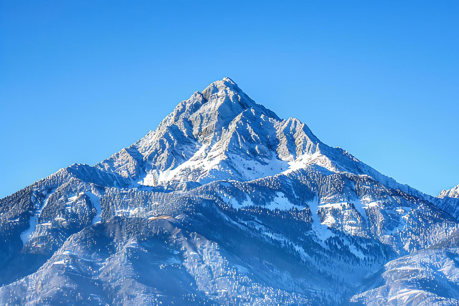 Majestic Mountain Peak Dominating the Landscape with a Clear Blue Sky Backdrop SnowCapped Heights a photo
