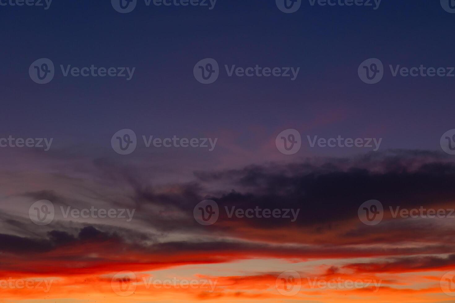 Dramatic sunset scene. Partly cloudy sky with orange clouds photo