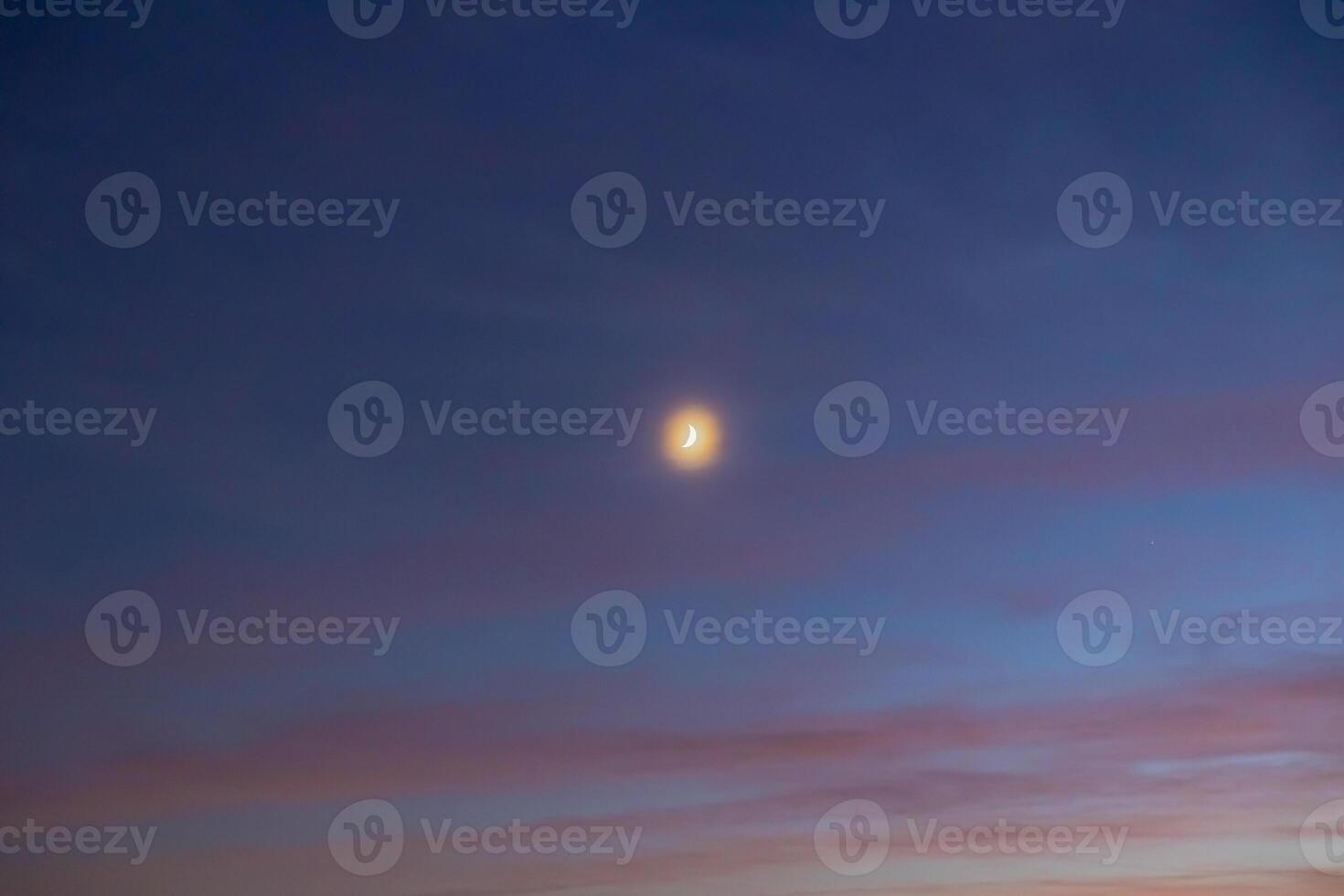 Crescent moon on the hazy sky. Ramadan or islamic concept photo