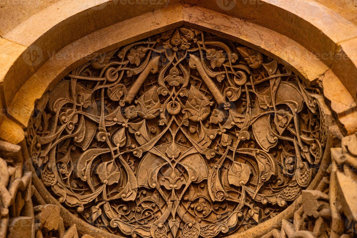 Carved stone decorations of the mihrab of Great Mosque of Divrigi in Sivas Turkey photo